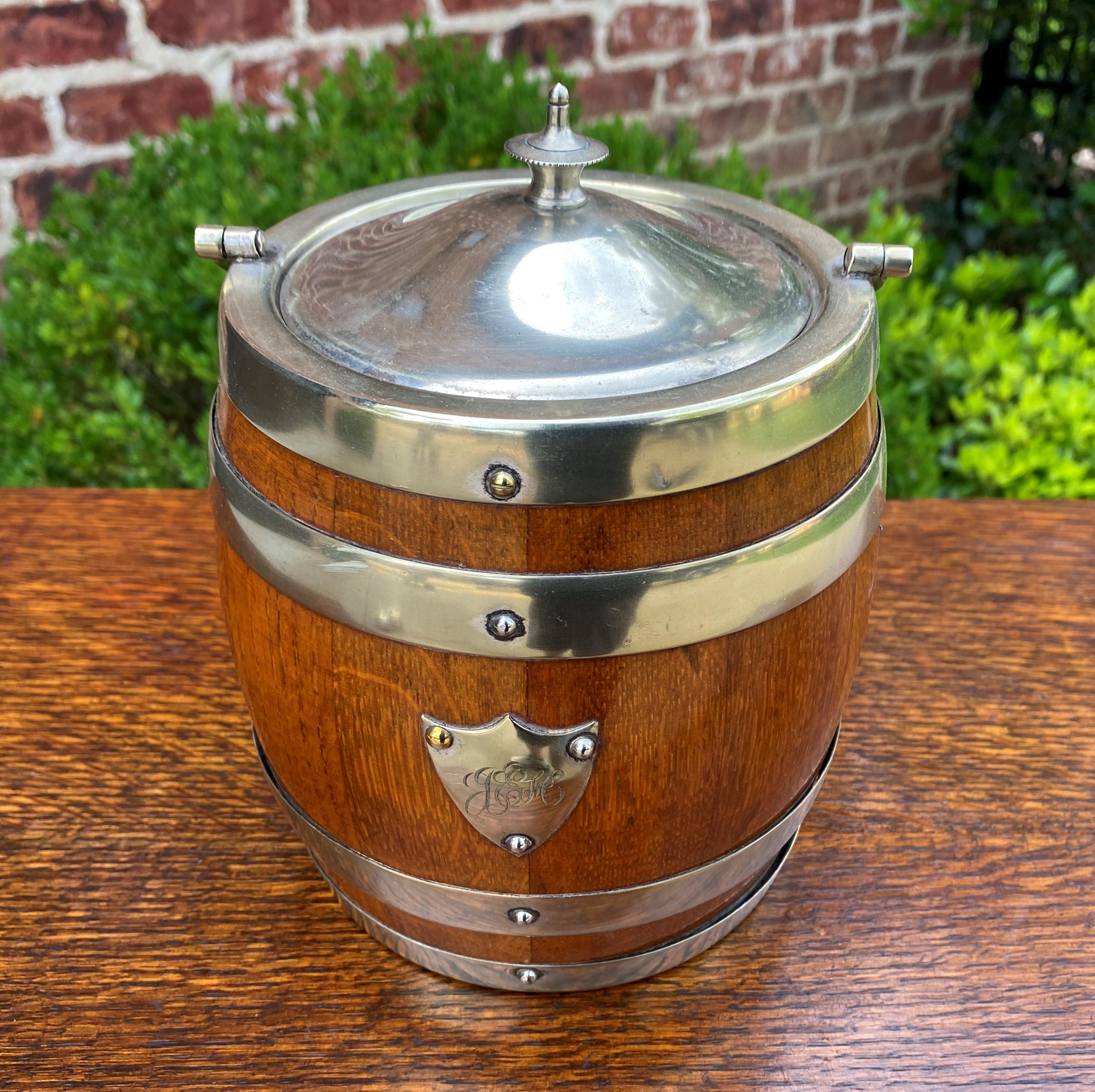 Charming Antique English Oak Biscuit Barrel or Small Ice Bucket with Silverplate Lid~~c. 1930s
 

 Charming decorative accent piece for any room in today's home or office~~engraved shield and double banded body~~interior porcelain lining

