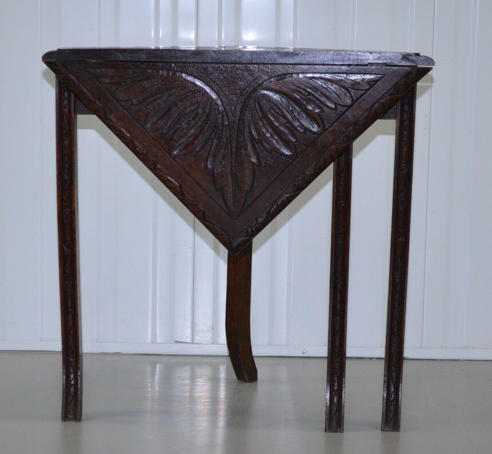 We are delighted to offer for sale this rare antique english oak lamp, corner table with drop leaf. The table has a hand-carved triangular top with the drop leaf section lifting up forming a square, standing on elegant legs the table is in excellent