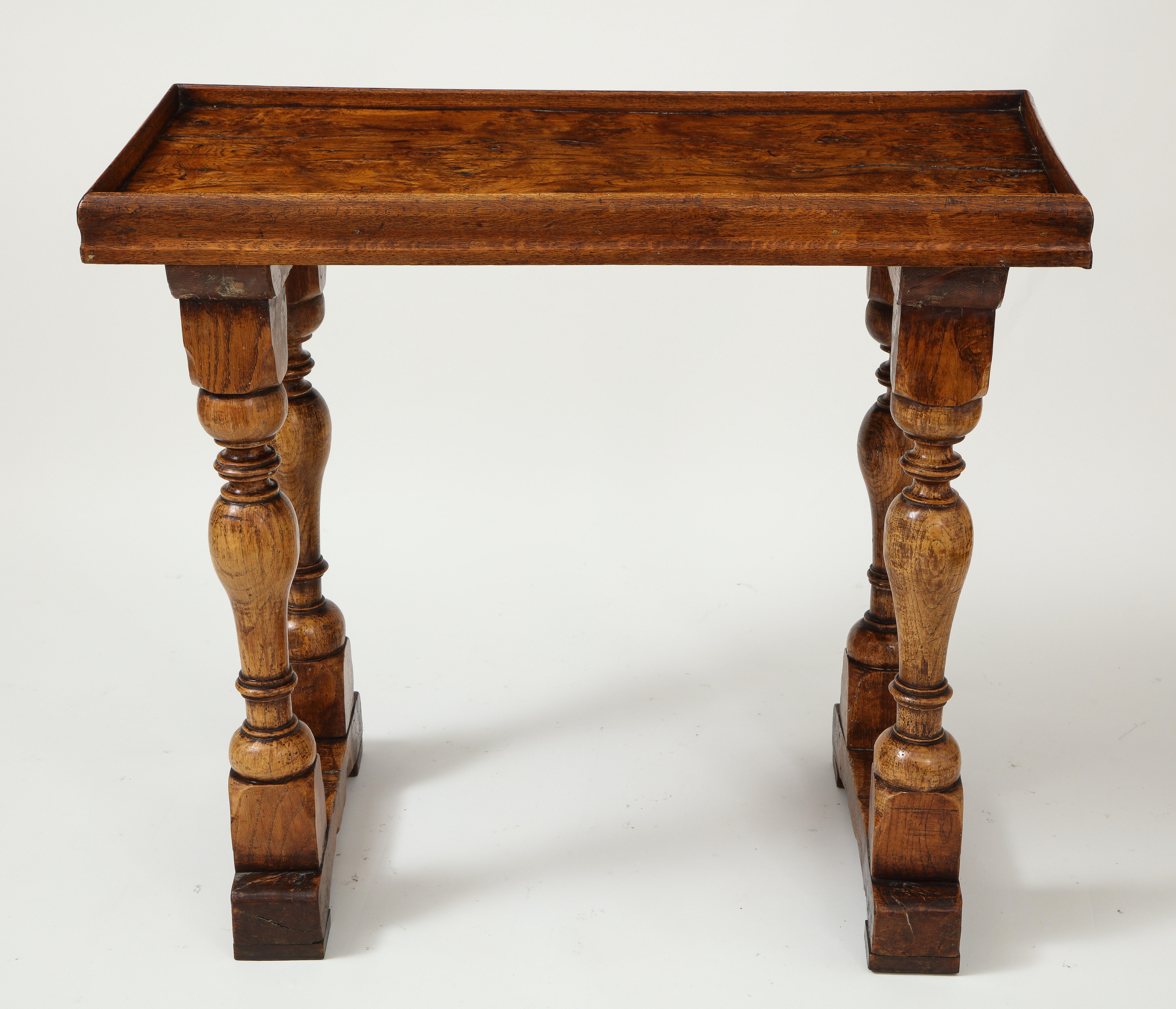 This Jacobean Revival piece incorporates 17th century elements, including the beautifully patinated, single board top. Raised on baluster-form supports joined by stretchers.