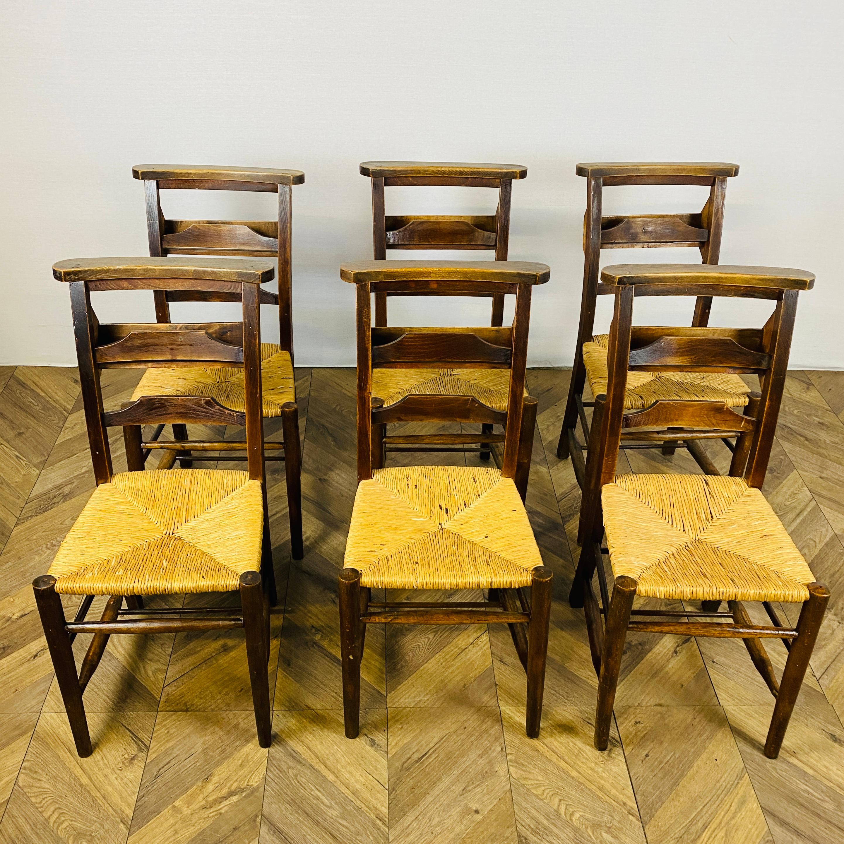 Antique English Oak Chapel / Dining Chairs, Set of 6, circa Late 19th Century.

The chairs are constructed in solid oak with shaped backs and rush seats, with a rich patina.
The chair frames are in sturdy condition as are the rush seats, but do