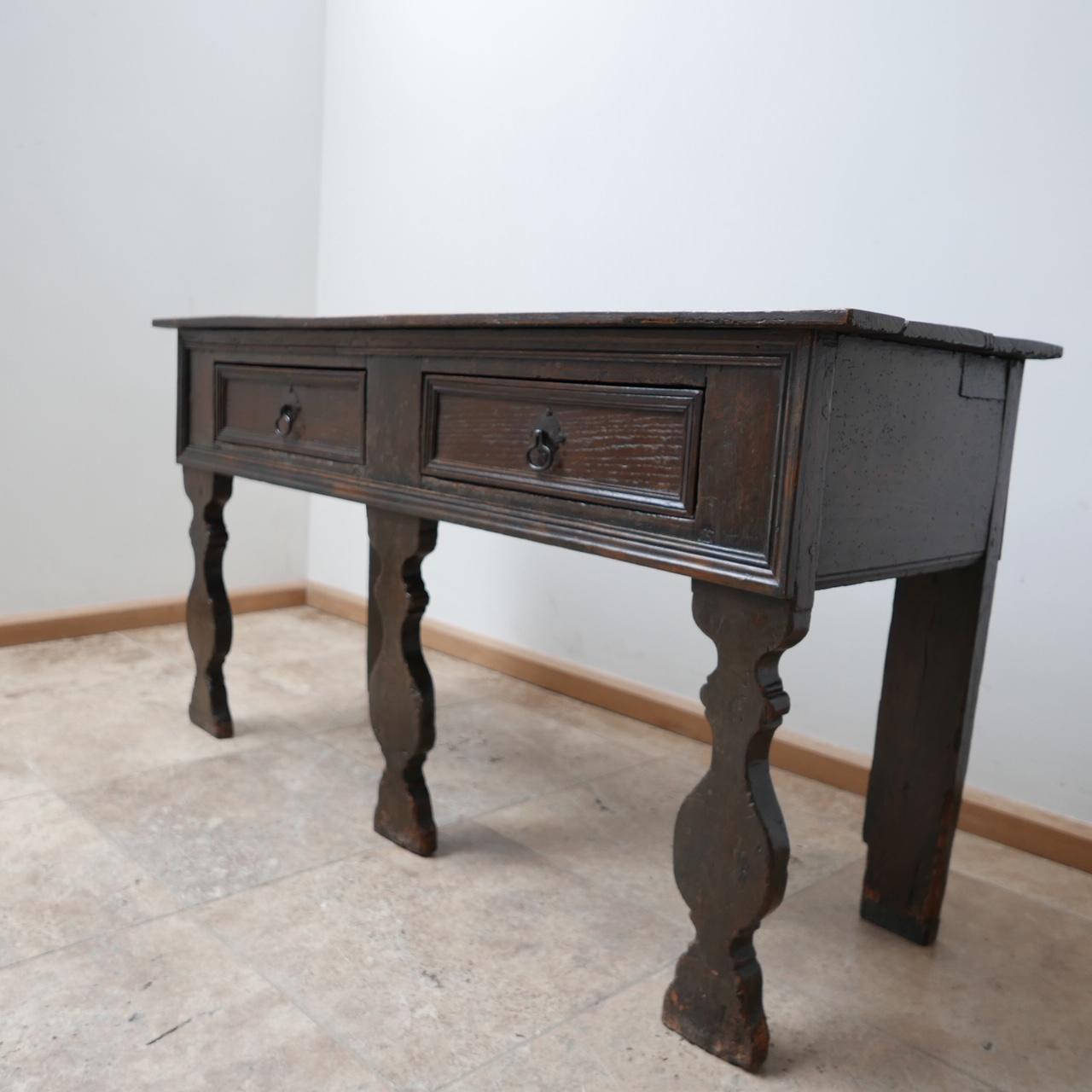 A 18th century and later oak dresser or sideboard. 

England, 18th century, with later antique wood additions. 

Very old but remaining wildly contemporary in its form. 

Splits to the top and wear commensurate with age. 

Sits low, so would