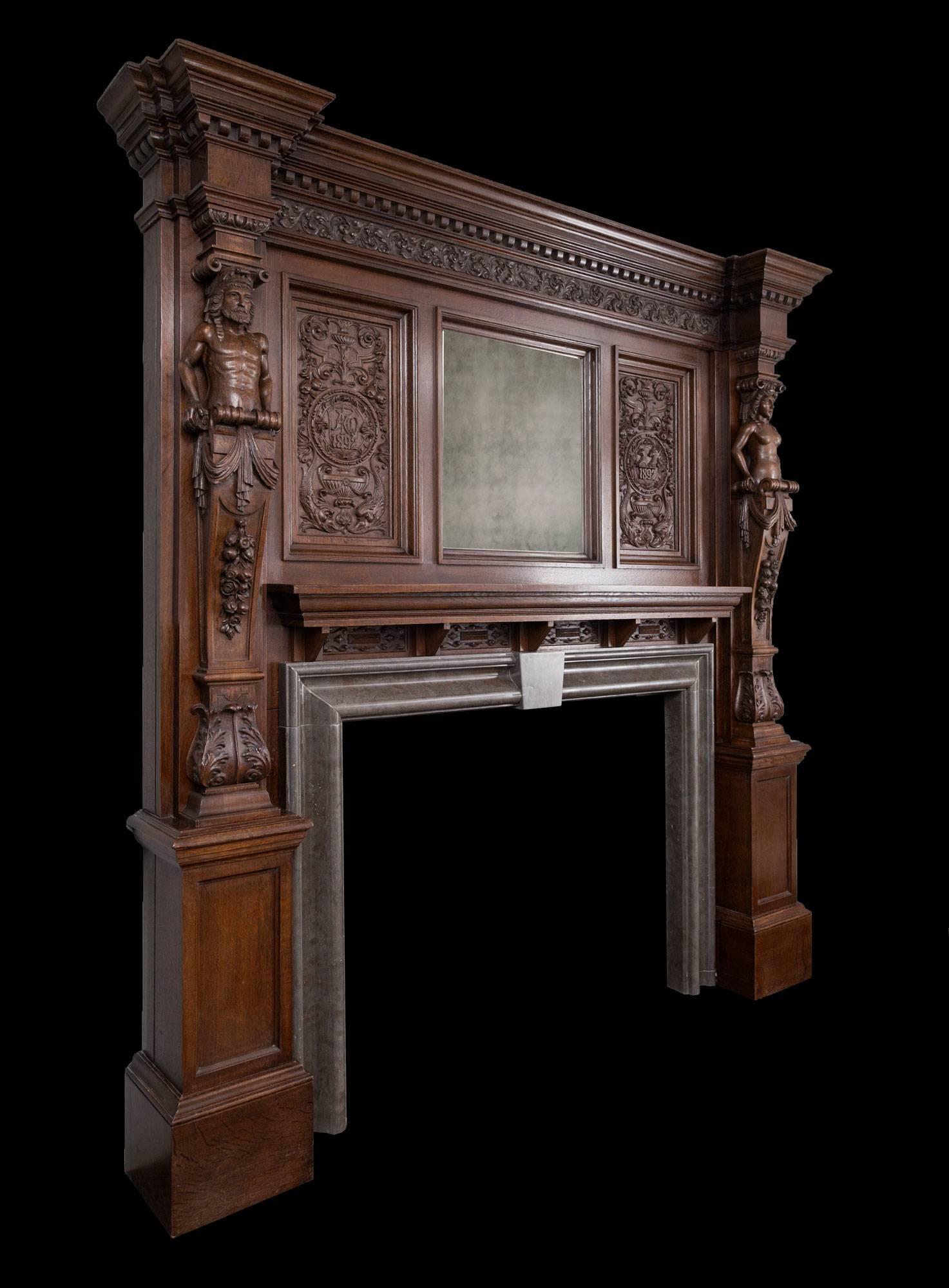 Magnificent antique English oak mantelpiece of exceptional quality. 

Large in scale and beautifully carved from oak in the Elizabethan Renaissance Revival style. A centre mirror is flanked by two exquisitely carved panels with the date of