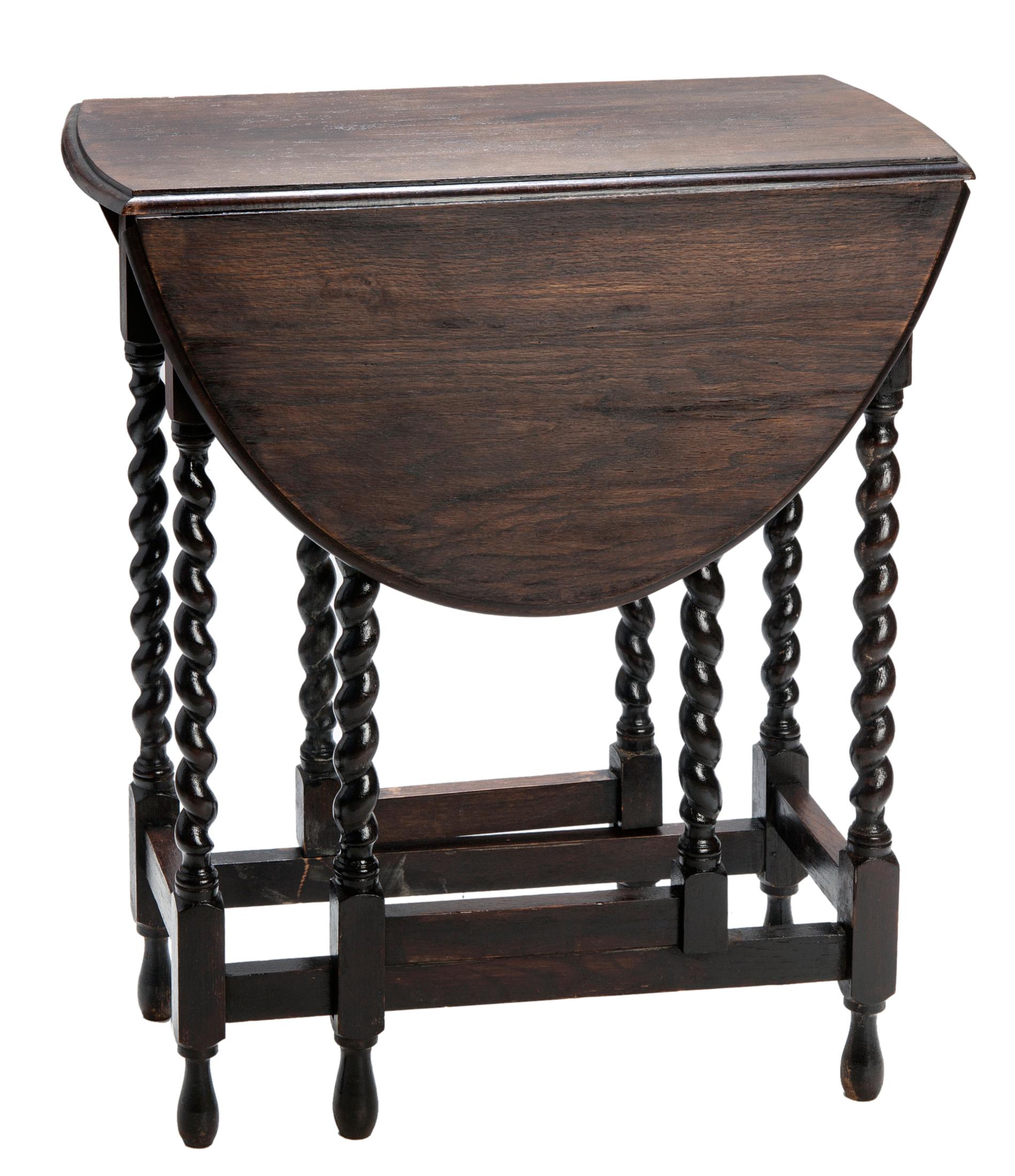 Small tuck-a-way oval drop leaf Oak table with fine barleycorn gate legs.
Slender narrow profile opens to a tapered oval. 
Professionally restored with a dark brown stained finish.