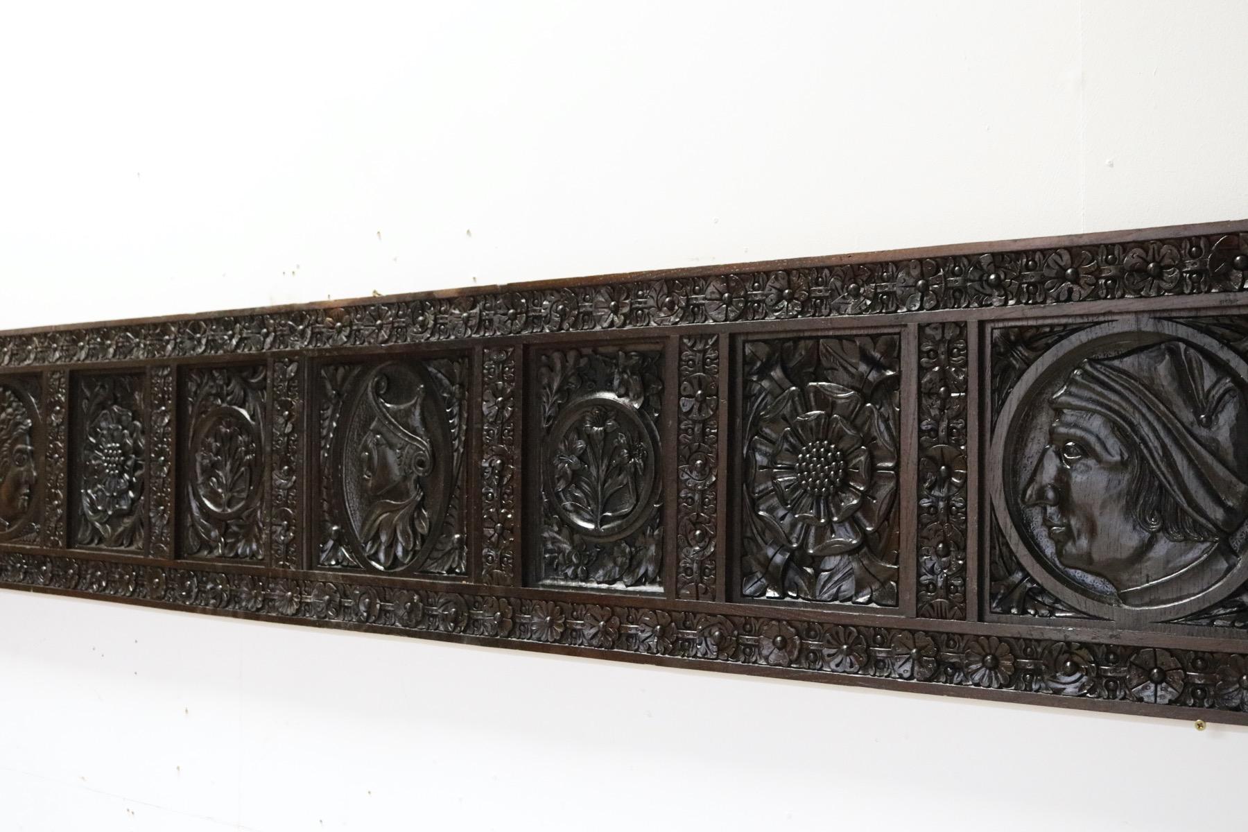 A reclaimed oak wall panel carved with foliage and heads. Adapted around 189o, utilising earlier elements. We have many other panels from the same property. Measure: (2.92m wide).