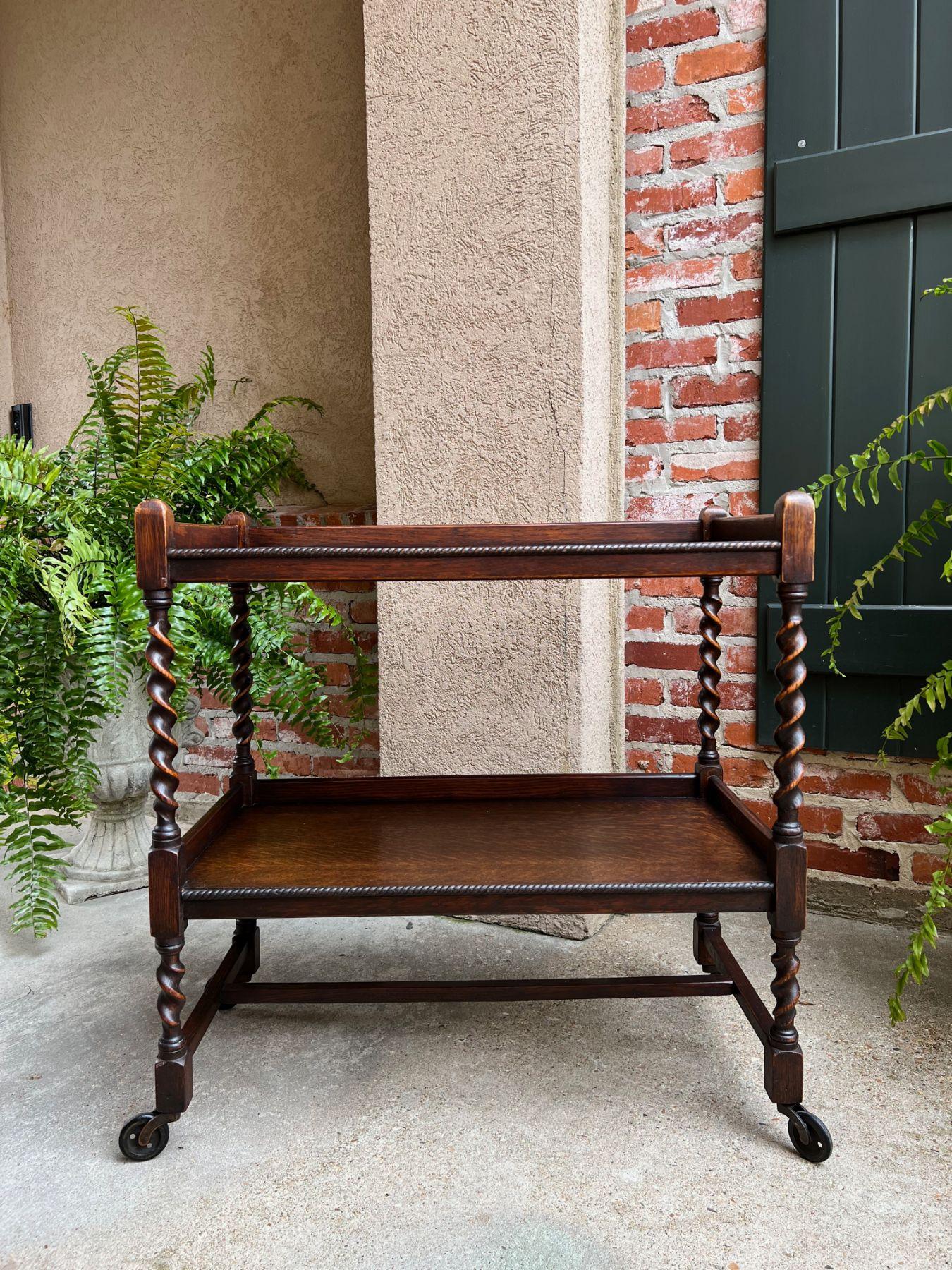 Antique English oak tea trolley drinks wine serving cart barley twist dumbwaiter.

Direct from England, a beautiful antique English oak tea trolley or “dumbwaiter” serving cart.
Excellent for entertaining and great for use as a side table or sofa