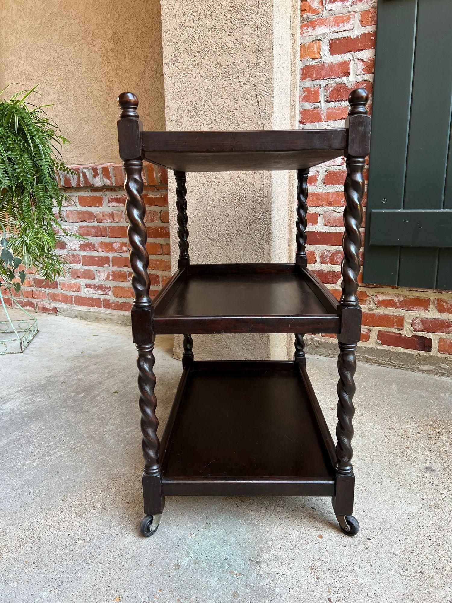 Antique English oak tea trolley drinks wine serving cart barley twist dumbwaiter.
 
Direct from England, a beautiful antique English oak tea trolley or “dumbwaiter” serving cart. Excellent for entertaining and great for use as a side table or sofa
