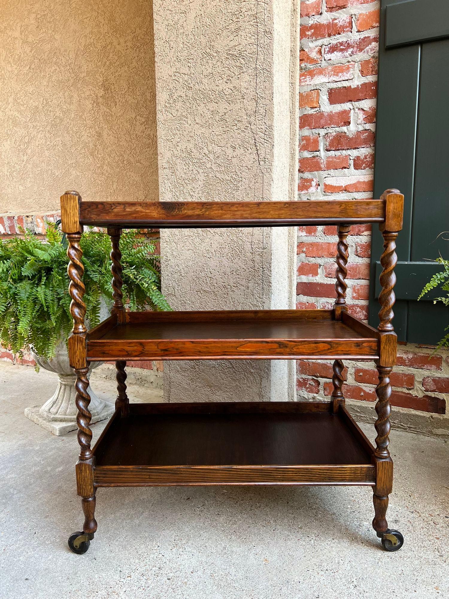 Antique English Oak Tea Trolley Drinks Wine Serving Cart Barley Twist Dumbwaiter.

Direct from England, a beautiful antique English oak tea trolley or “dumbwaiter” serving cart. Excellent for entertaining and great for use as a side table or sofa