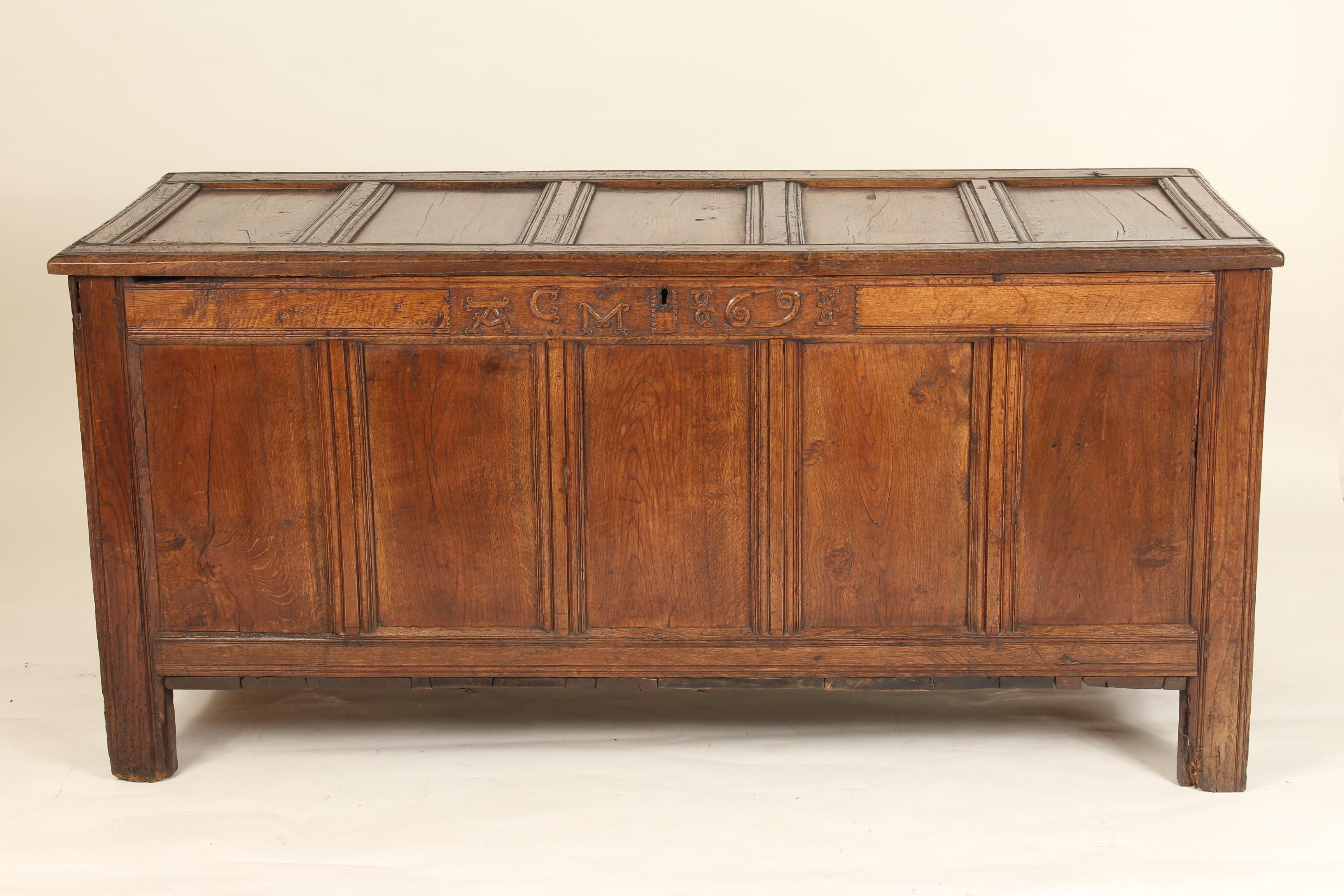 Large scale antique English oak trunk, 18th century. With carved initials and date numbers CM and 69 for 1769.
