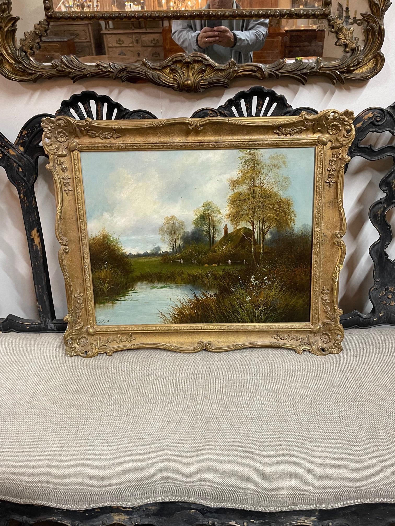 Beautiful antique English oil painting on canvas signed by H Wallace. Featuring a soothing landscape scene with a cottage and a river in a nice giltwood frame. Pretty!!