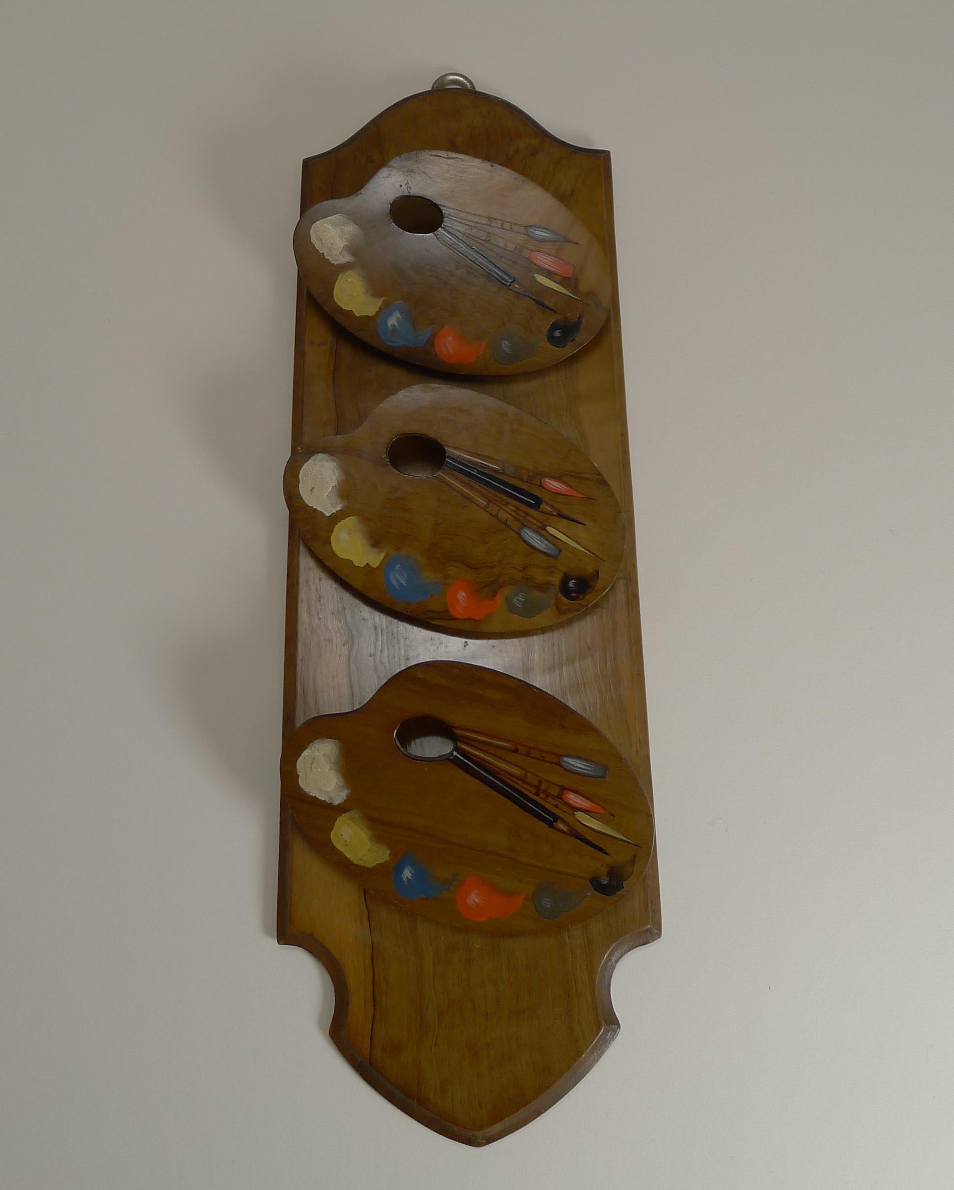 A most unusual late Victorian wall-hanging letter or note tidy, perfect for the artist in your life.

The carved wood is made from exotic Olivewood with the three hinged compartment fronts carved in the form of Artist's Palettes, all hand-