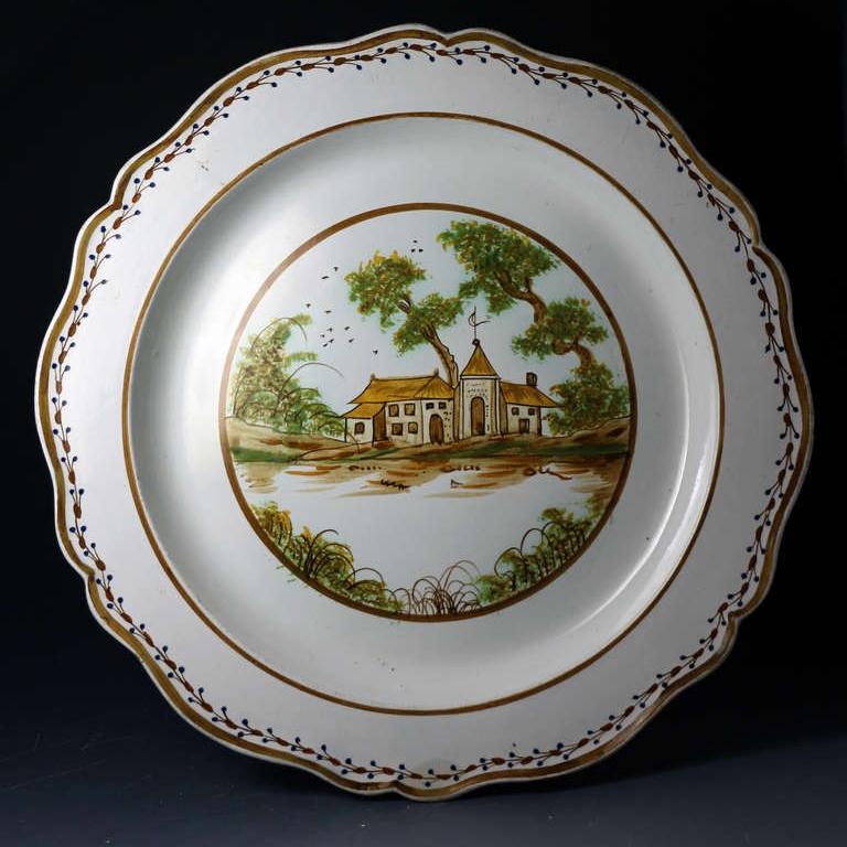 A fine Prattware pottery silver shape charger is wonderful clean condition. The central panel is elegantly decorated with a view of manor house with trees. My qualified attribution is Swansea pottery.