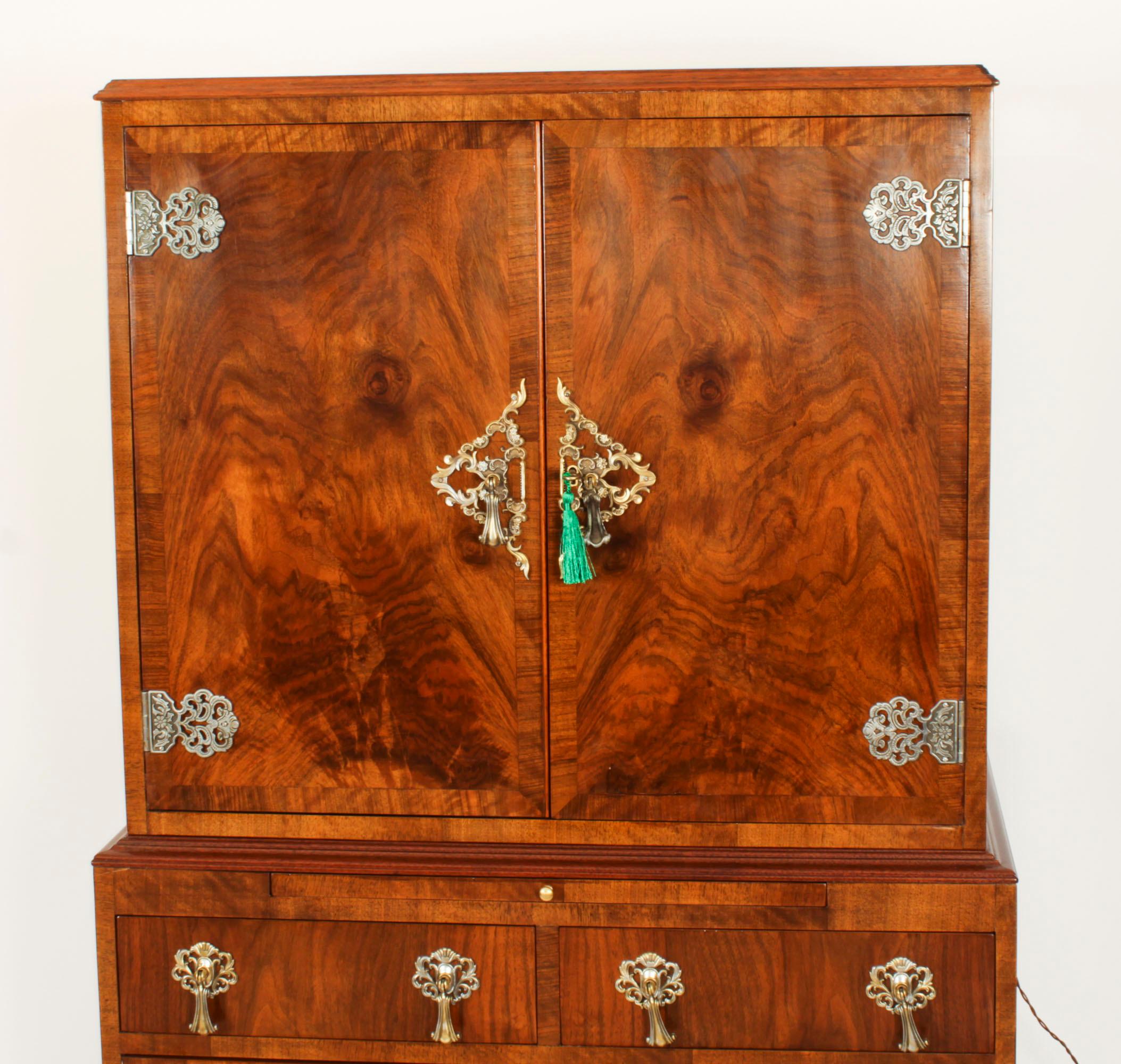 This is a stupendous antique English burr walnut cocktail cabinet by M&T London Ltd, mounted with heavy ormolu hinges and elaborate escutcheons complete with  the highest quality glassware and 10 Whisky miniatures, circa 1920 in date.

The upper