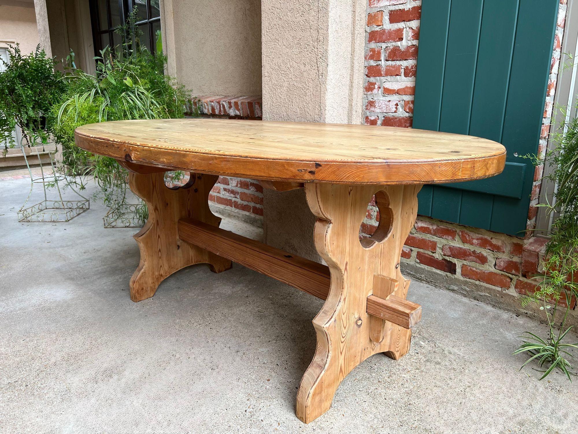Antique English OVAL Trestle Table PINE Kitchen Farmhouse Rustic c1920.

Direct from England, this lovely antique pine table beautifully balances English country charm and craftsmanship.
The thick, pine oval top with lovely patina, rests on shaped