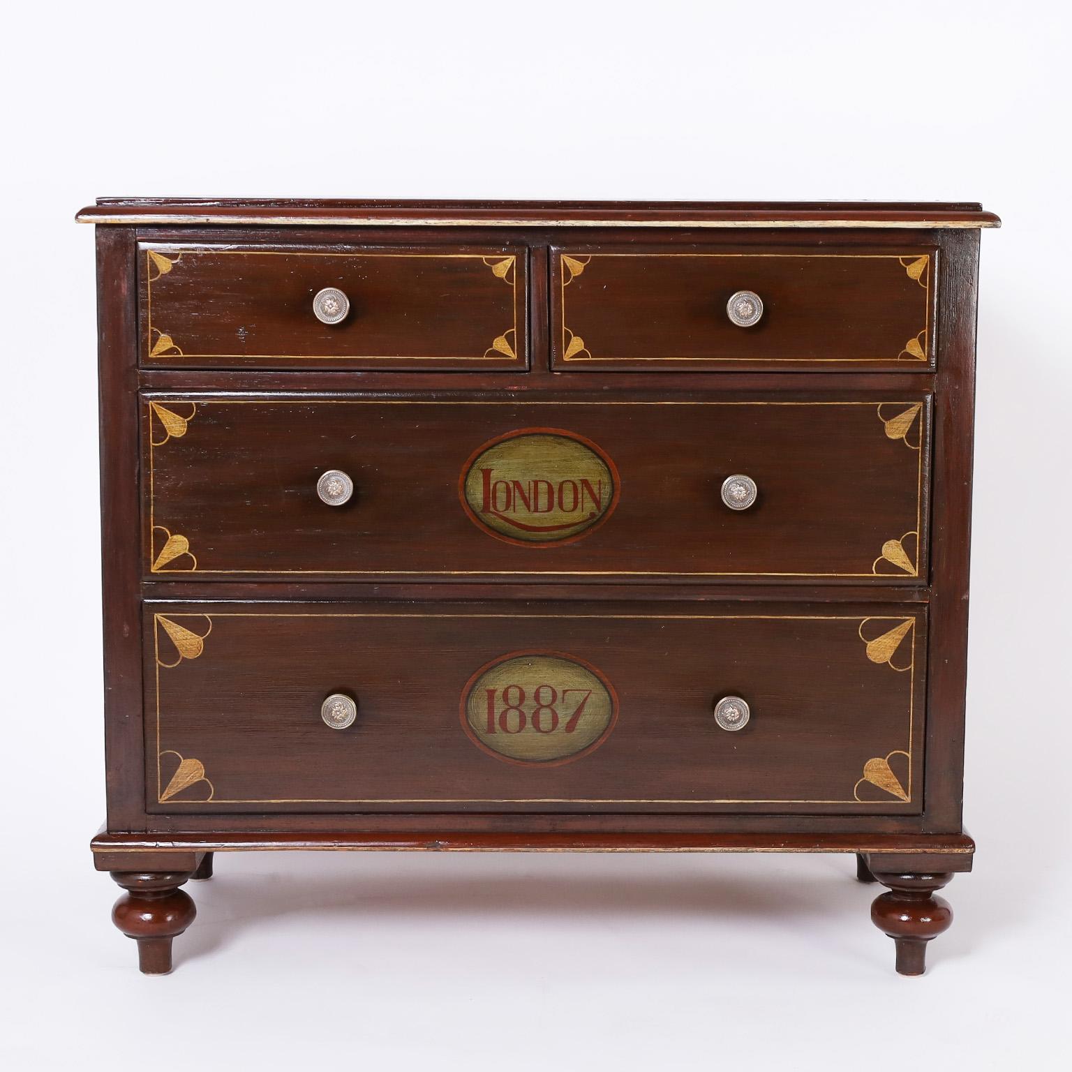 Standout antique English chest hand crafted in pine with four drawers and turned feet, painted and decorated later. Likely from the Cafe Royal Hotel London, which had its contents auctioned off in 1979.