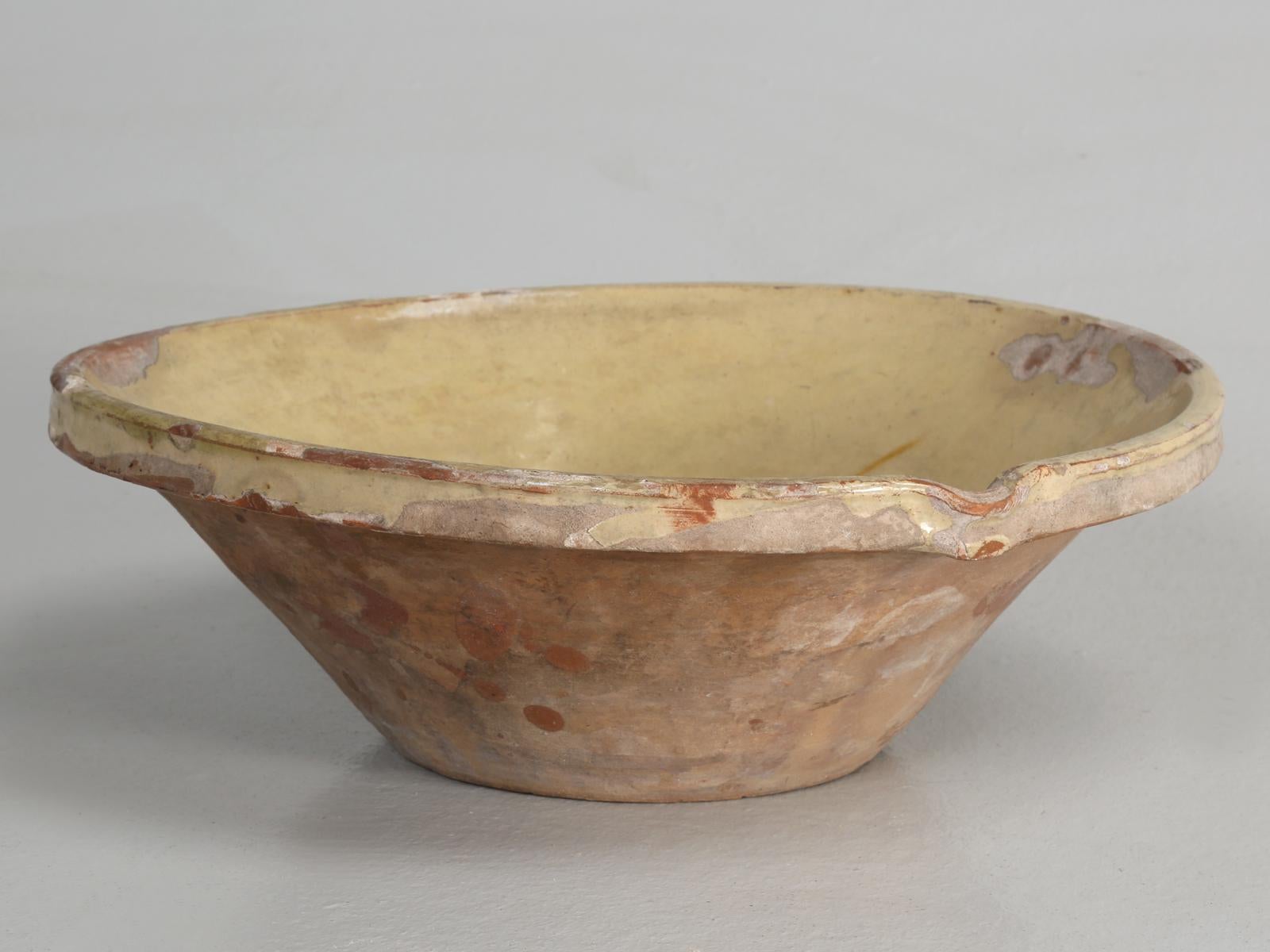 A very antique English pancheon bowl, made from earthenware (from red of buff clay) farmhouse dairy bowl, typically used to allow the milk to separate from the cream and also used in bread making and proving. I have to assume that the British, would