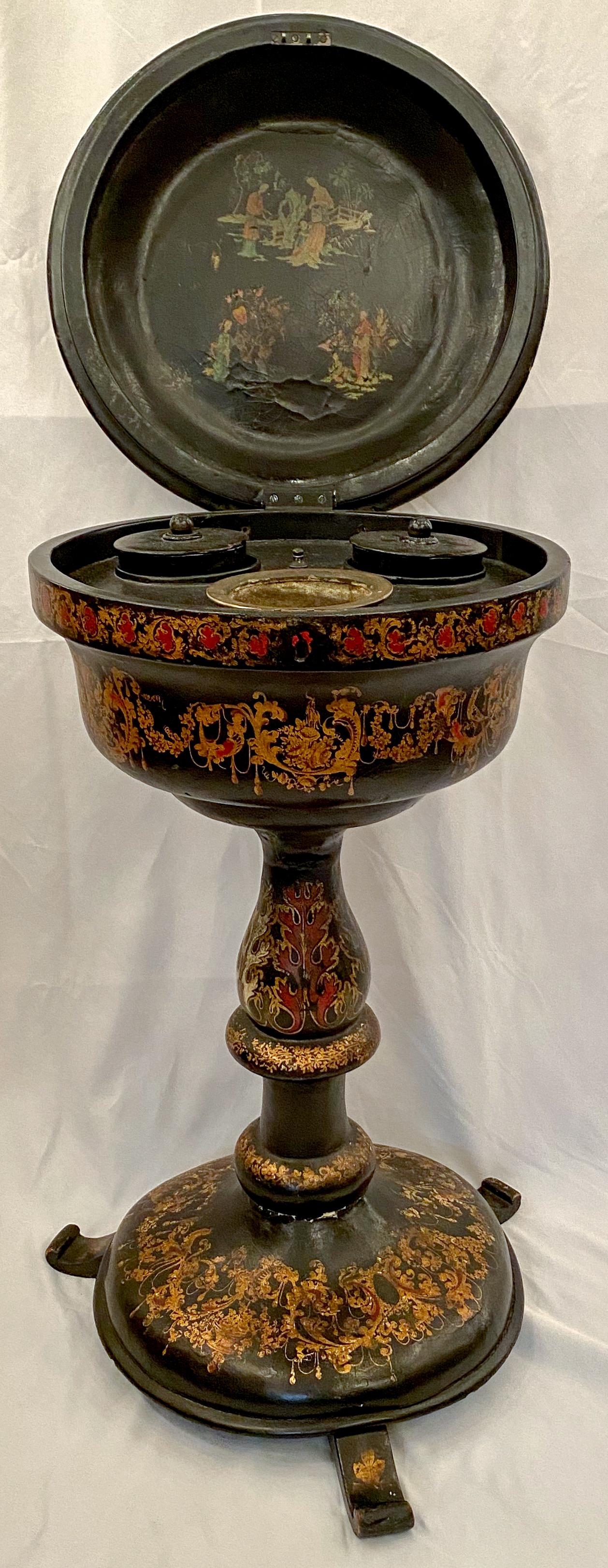 A teapoy is a small pedestal table used for tea service comprised of a box attached to a tripod base. The two lidded boxes inside were for fresh tea leaves and the empty bin between for used tea leaves. In the late 19th century, the teapoy was a