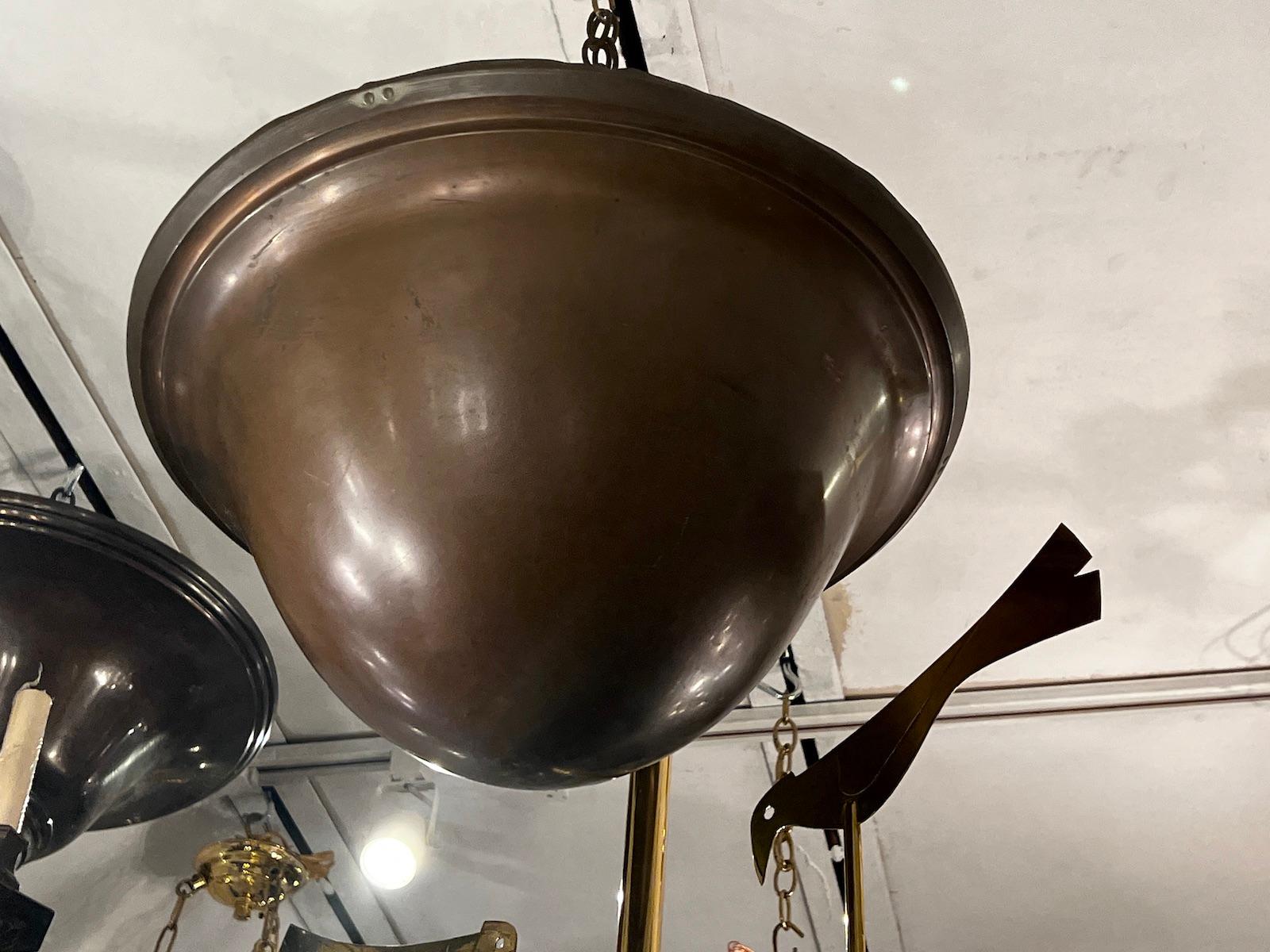 A circa 1920’s English bronze pendant light fixture with four interior lights.

Measurements:
Drop: 20?
Diameter: 18?.