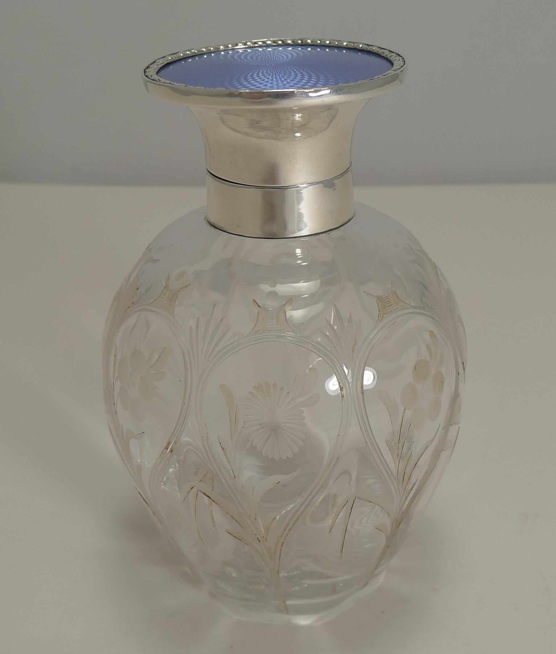 Pretty as a picture, this English Edwardian perfume or Scent bottle is made of hand-blown crystal with stunning floral wheel engraved decoration all around, lovely quality and very tactile.

The collar and hinged lid are made from English sterling