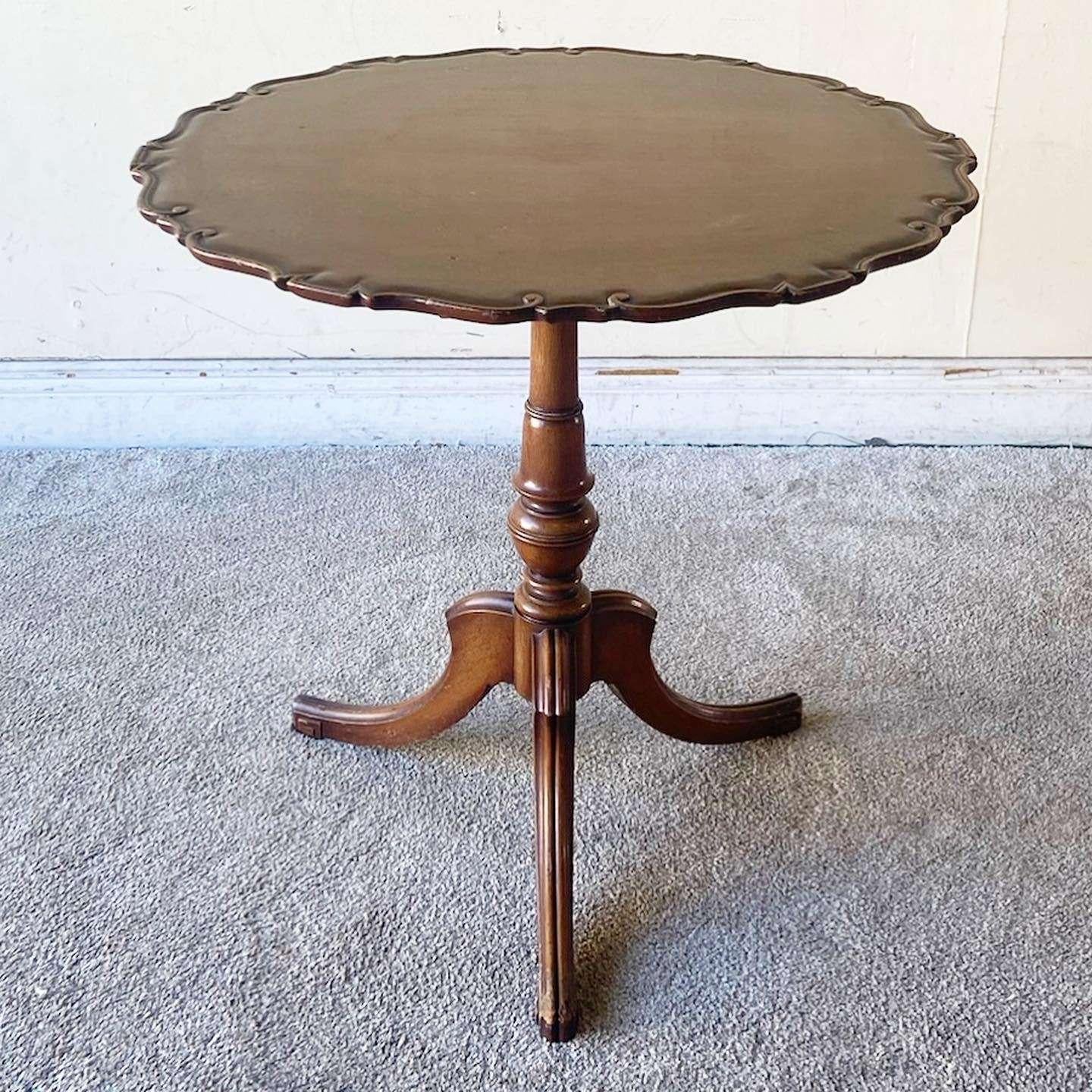 Exceptional antique English pie crust table. Features a mahogany finish with a three leg pedestal base.
