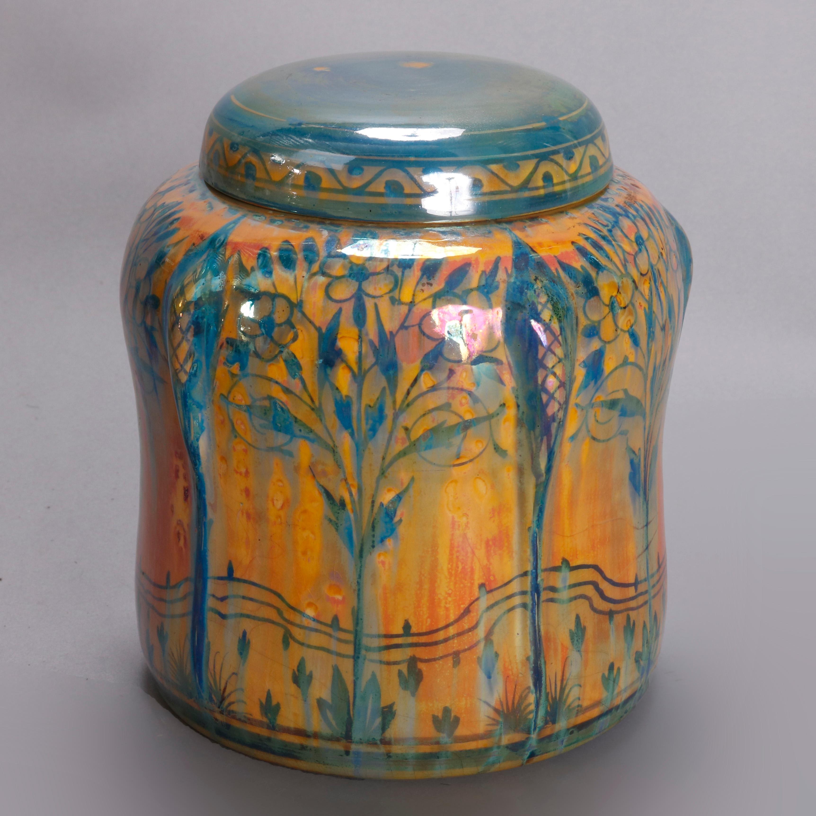 An antique English art pottery lidded biscuit jar by Pilkington offers faceted form with stylized landscape and tree decoration, signed on base as photographed, 20th century


Measures: 5.75