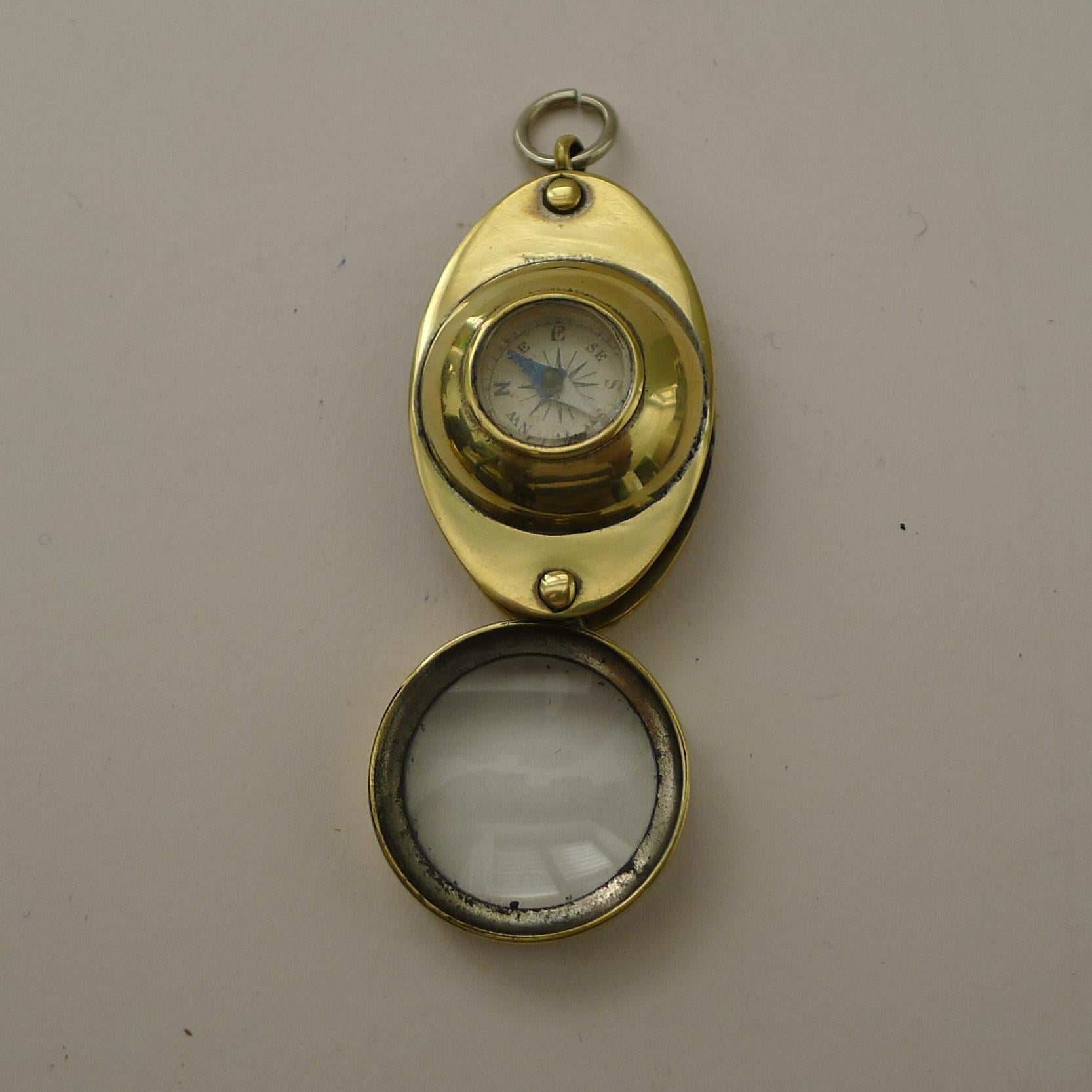 A charming little folding loop or magnifying glass made from brass, dating to the early twentieth century, c.1920.

What of course makes it highly collectable is the inset working compass. A novelty piece in excellent condition. 1 7/8