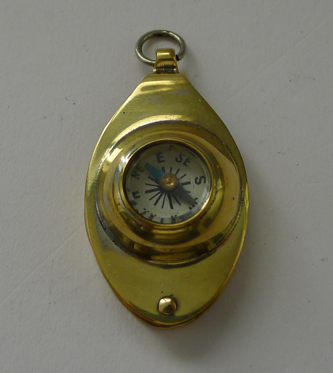 A charming little folding loop or magnifying glass made from brass, dating to the early twentieth century, c.1920.

What of course makes it highly collectable is the inset working compass. A novelty piece in excellent condition. 1 7/8
