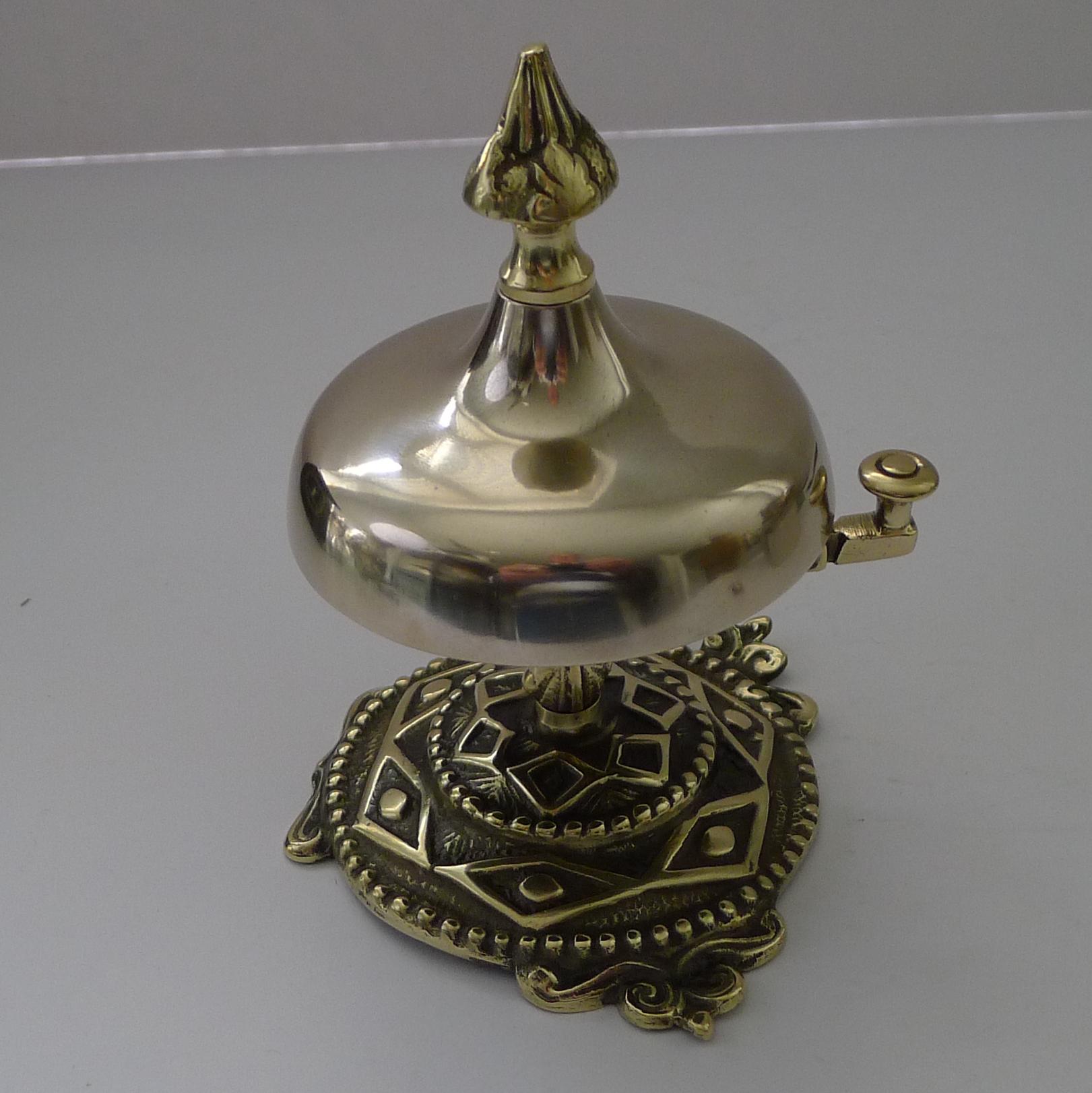A wonderful and highly decorative desk or counter bell, my favourite kind with the more unusual clapper to the side rather than the ones you ring from the top. The hinged clapper is released and gives a clear and authoritative ring.

A true