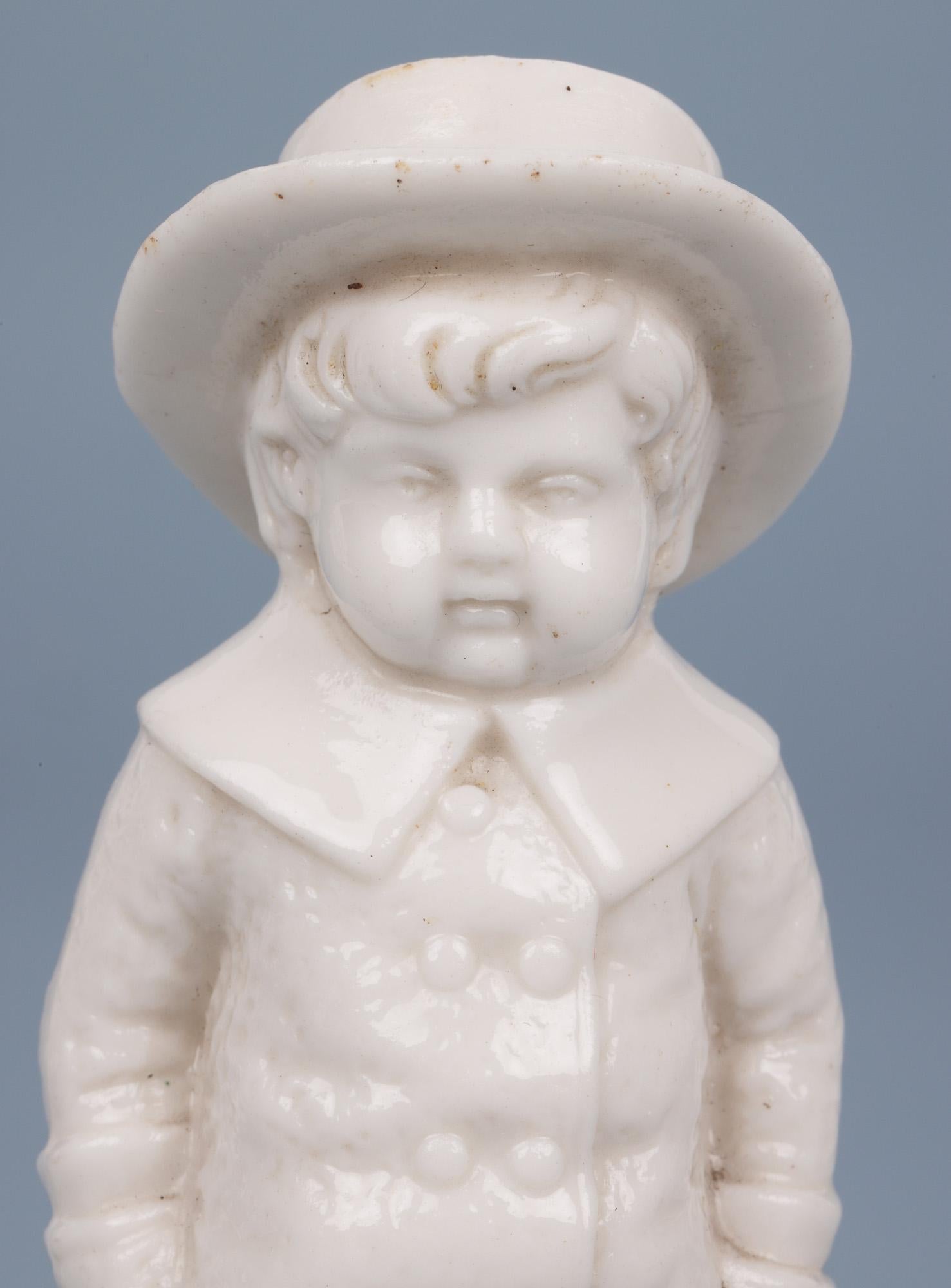 A delightful antique English porcelain pounce or pepper pot modelled as a young boy wearing a full length coat and hat dating from the 19th century. This quality pot is very lightly made reminiscent of the quality of Royal Worcester or similar and