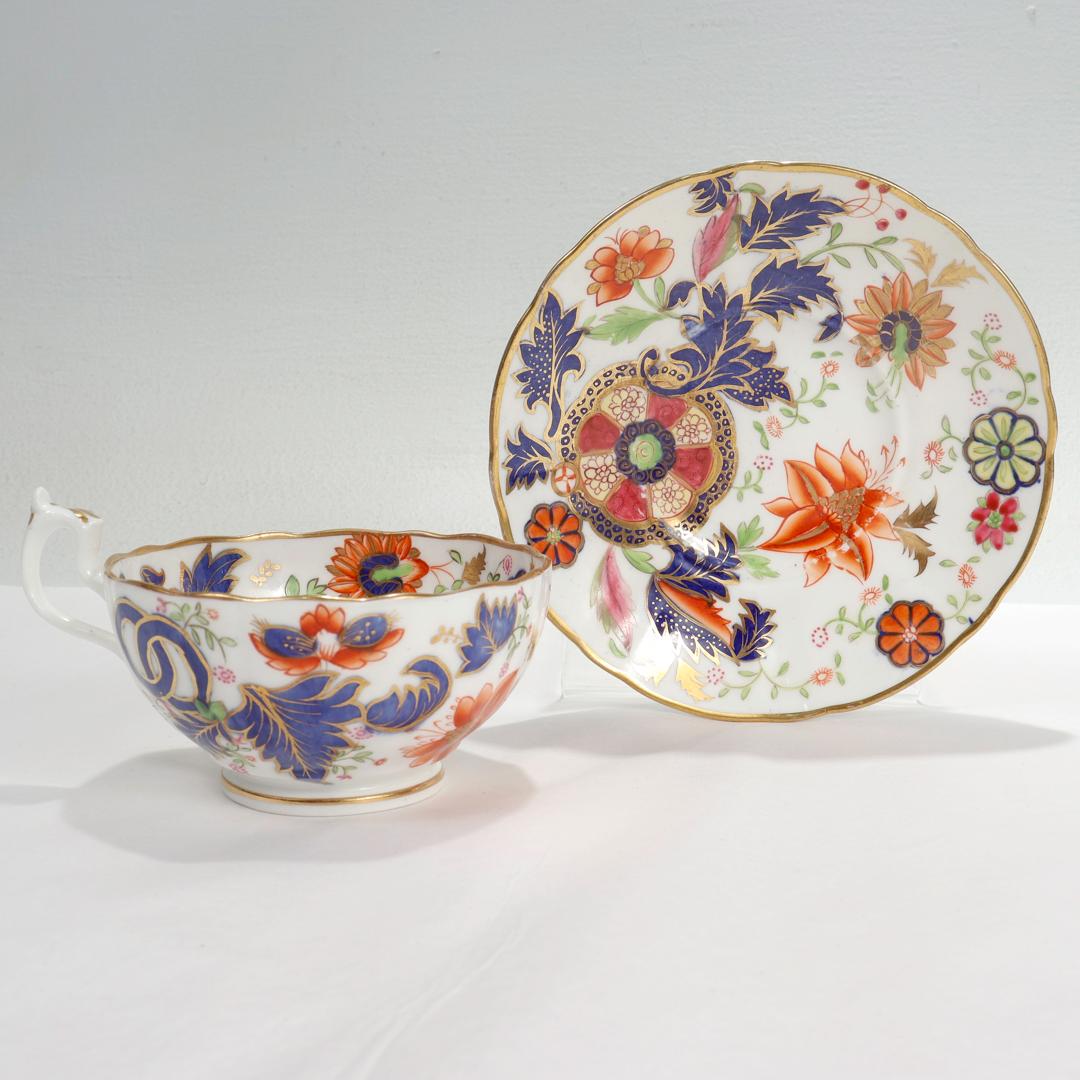 A fine antique porcelain cup and saucer.

In the Pseudo-Tobacco Leaf pattern, mimicking the Chinese Export pattern of the late 18th century.

Attributed to Copeland Spode.

Both cup and saucer have a gilt scalloped rim and are decorated in