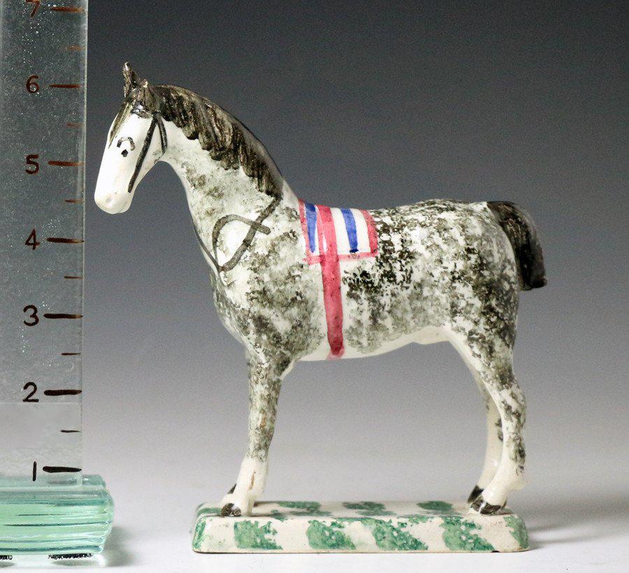 A fine pottery figure of a standing horse on thin base and attributed to the St. Anthony's pottery Newcastle upon Tyne England. A charming and elegant example finely potted.
