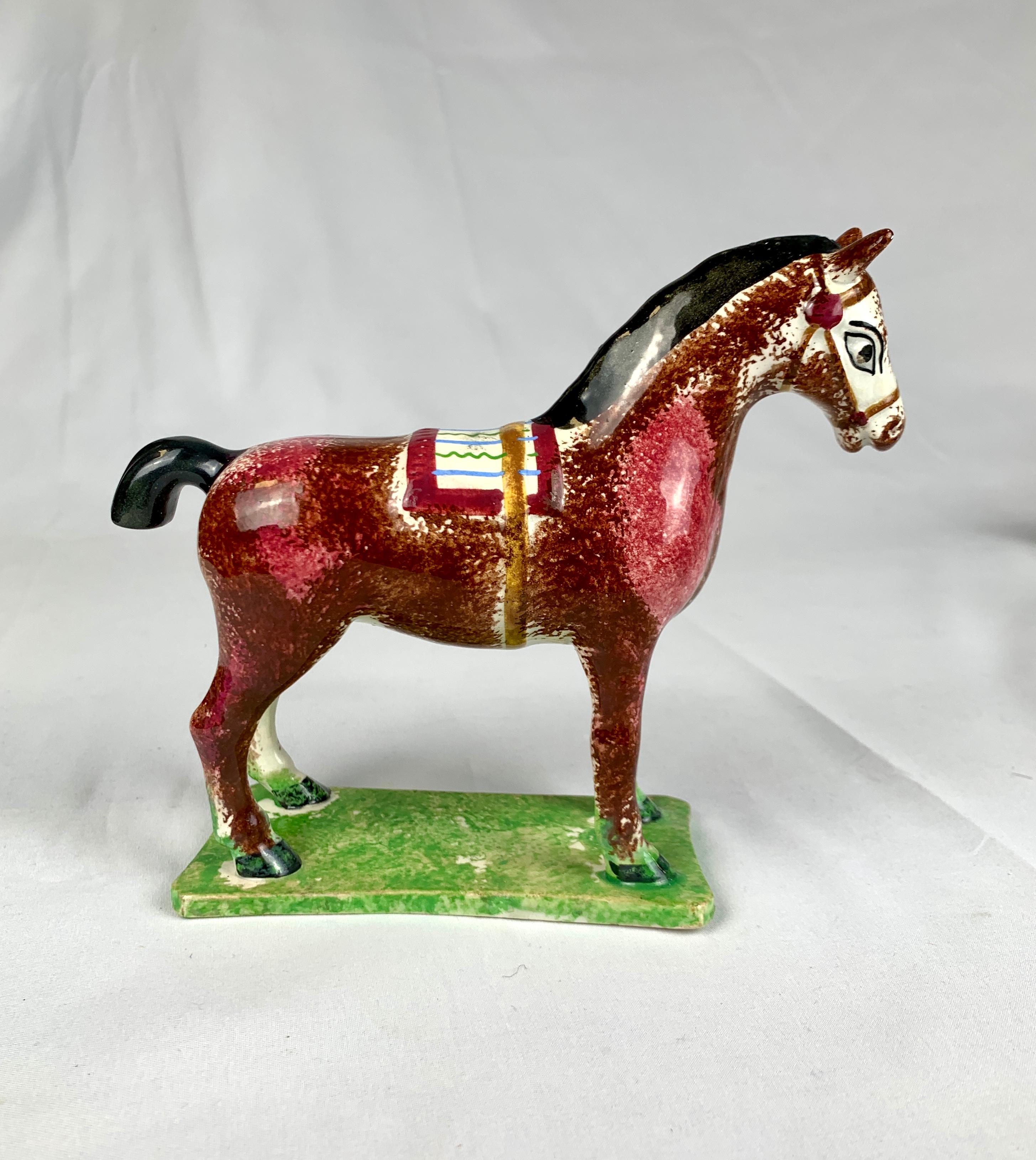 This pottery figure of a horse is sponge decorated in shades of pink and brown.
It was made at St. Anthony’s Pottery, located in Newcastle Upon Tyne, England, between 1800 and 1810.
The coat’s colors were created using oxides painted and covered in