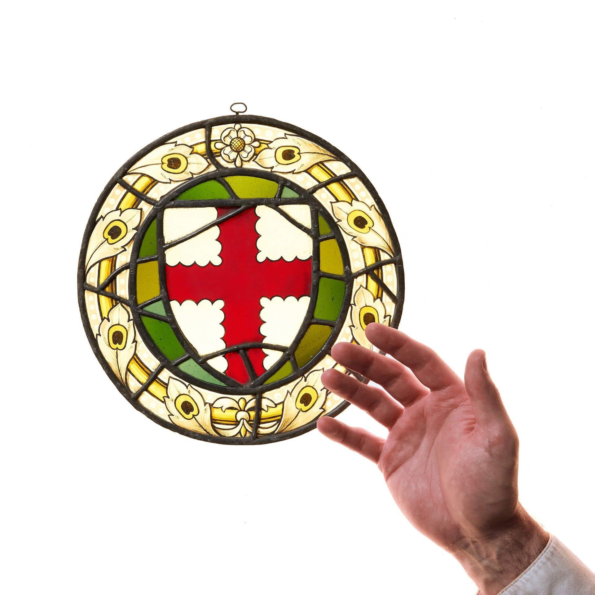 Petit vitrail anglais ancien représentant un pseudo-armorial de la croix de Saint-Georges, vers 1900.

Le pseudo-armorial reprend le rouge et le blanc caractéristiques de la croix de Saint-Georges en forme de bouclier, entouré de verre vert et