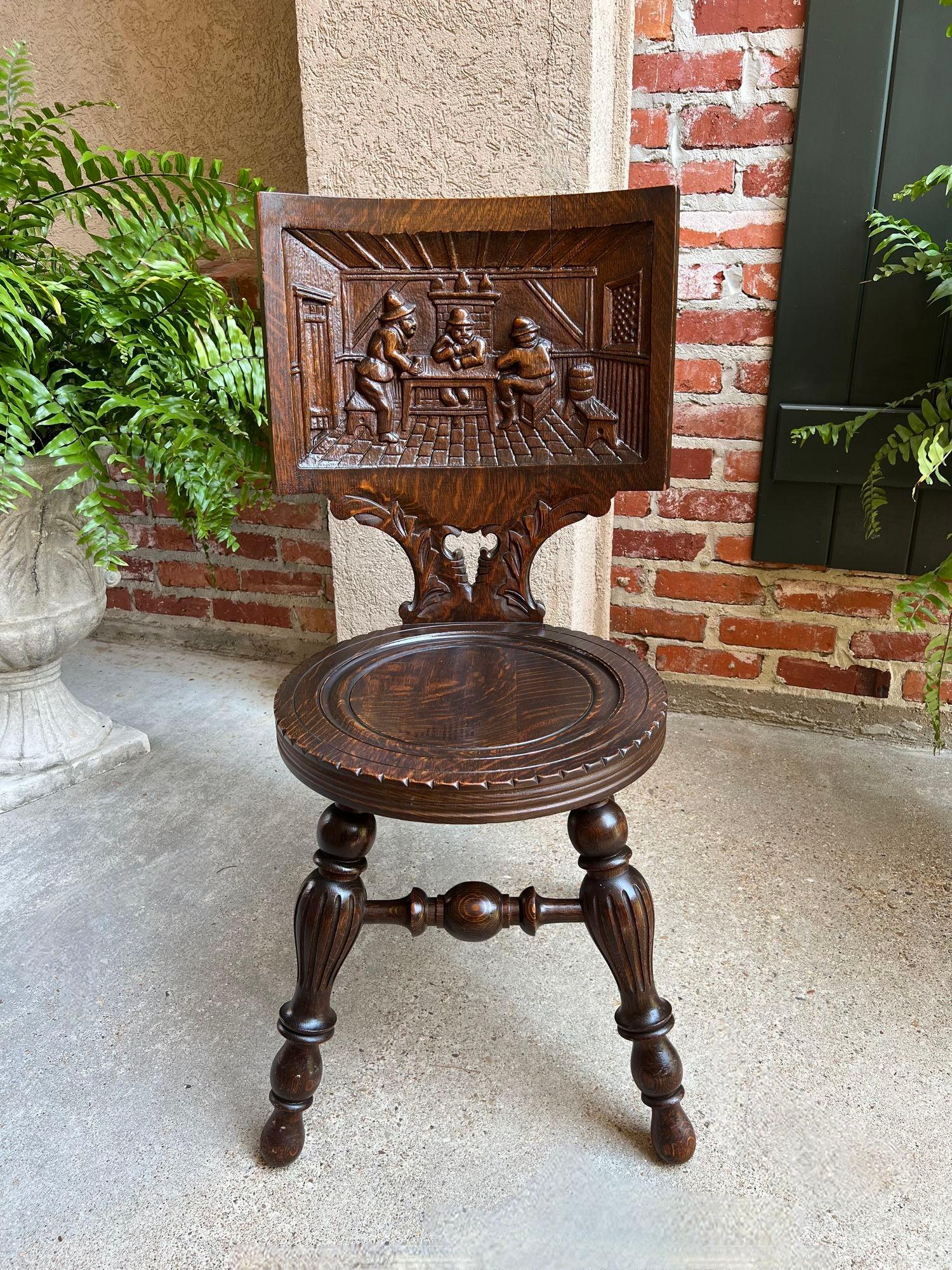 Antique English Pub Chair Fireplace Hearth Carved Tiger Oak Breton Brittany.

Direct from England to us, a charming antique English pub chair with a chair back that features a Breton carved scene of 3 men in a pub with fabulous details!
A grooved,
