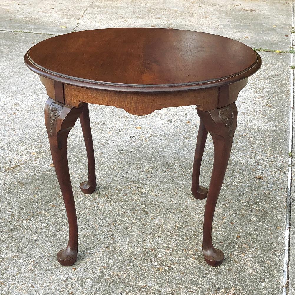 Antique English Queen Anne round end table will also make an excellent choice as a center table or a game table! Gracefully scrolled cabriole legs carved with a stylized crest and bellflower design, and are tipped with club feet. Crafted from fine