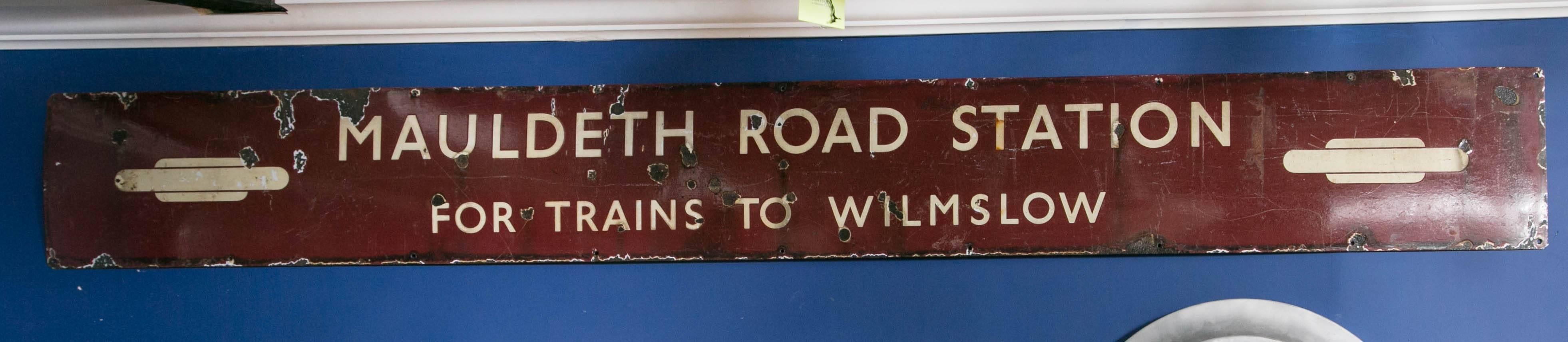 Vintage porcelain enameled, painted sign from the Mauldeth railway station which opened in 1909. This station serves the Ladybarn area of Manchester, England. When the rail line was electrified in the 1960s after using coal fired steam engines for