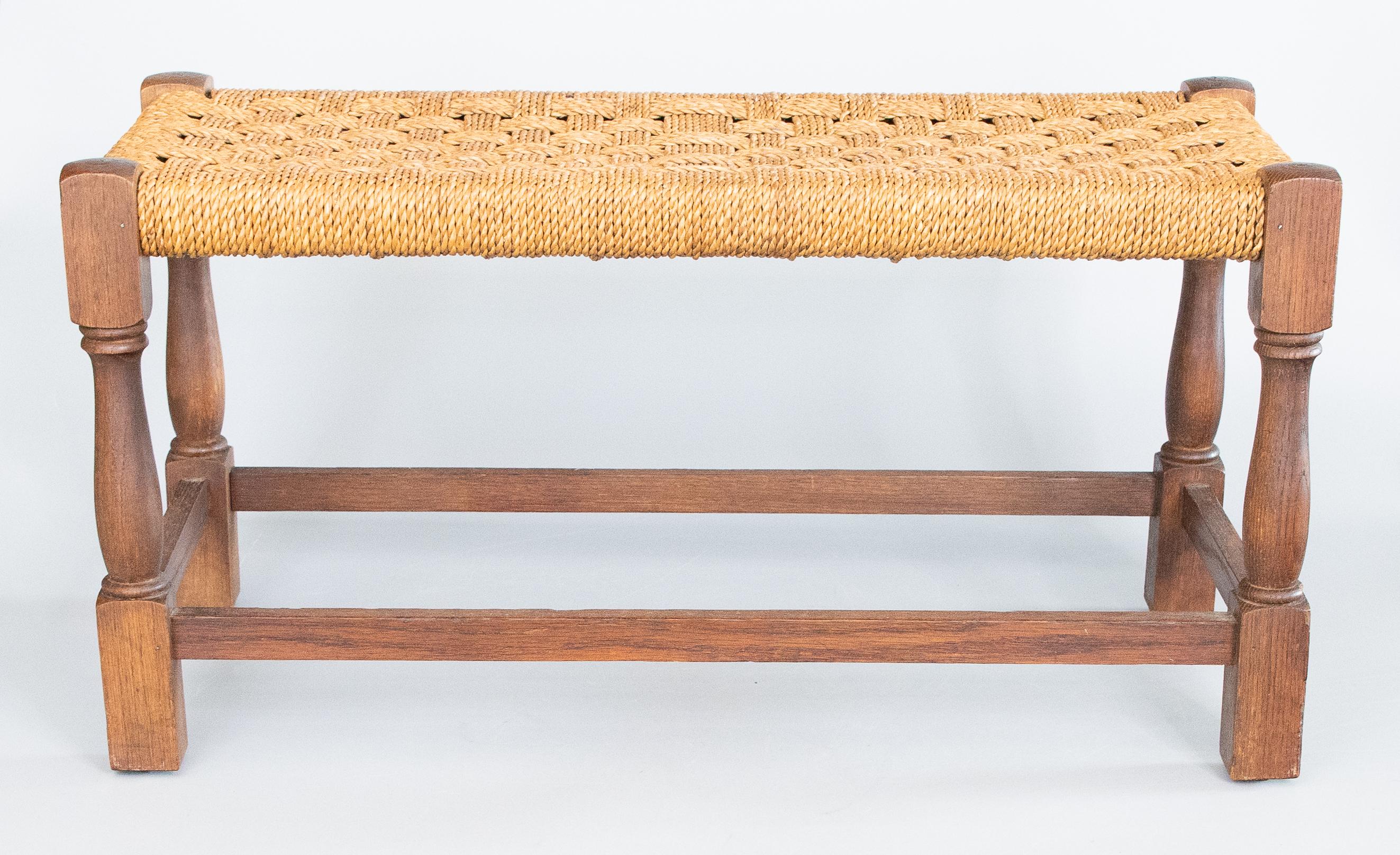 Superb antique early 20th-Century English oak stool / foot stool / bench with hand turned legs and stretchers and hand woven cording seat. This charming stool is a nice large size and would make a fine foot rest.

Dimensions
29.75ʺW × 13ʺD × 15.5ʺH