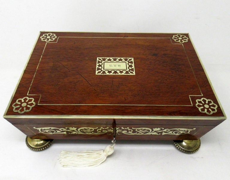An exceptionally fine quality example of a Lady’s or Gentleman’s English Regency Period polished brass mounted Flame Mahogany Inlaid Boulle Style Jewellery or Trinket Casket or Table Box made during the first quarter of the Nineteenth Century, of