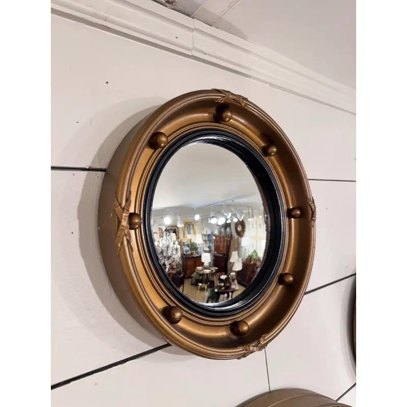 This all Late 19th century all original English Regency mirror would be right at home in the interior design styles of today. Fitted with hand-carved spherical knobs in the gold giltwood frame, the mirror would add to any ensemble wall collection.