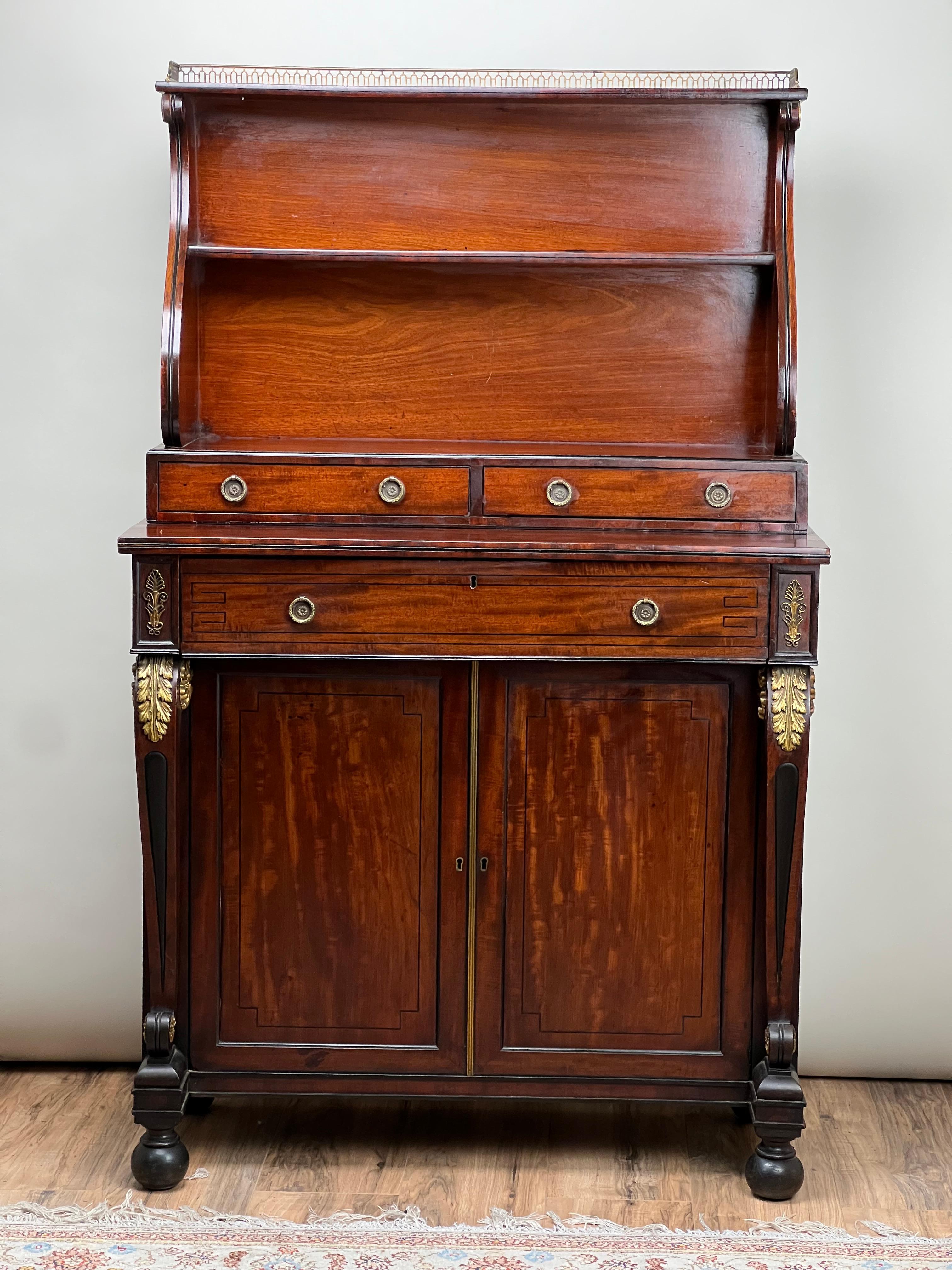 This exquisite English Regency mahogany butler’s secretary, dating to circa 1820, captures the grandeur and functionality of early 19th-century design. The mahogany boasts a rich, deep patina, enhanced by the elegantly curved sides of the open