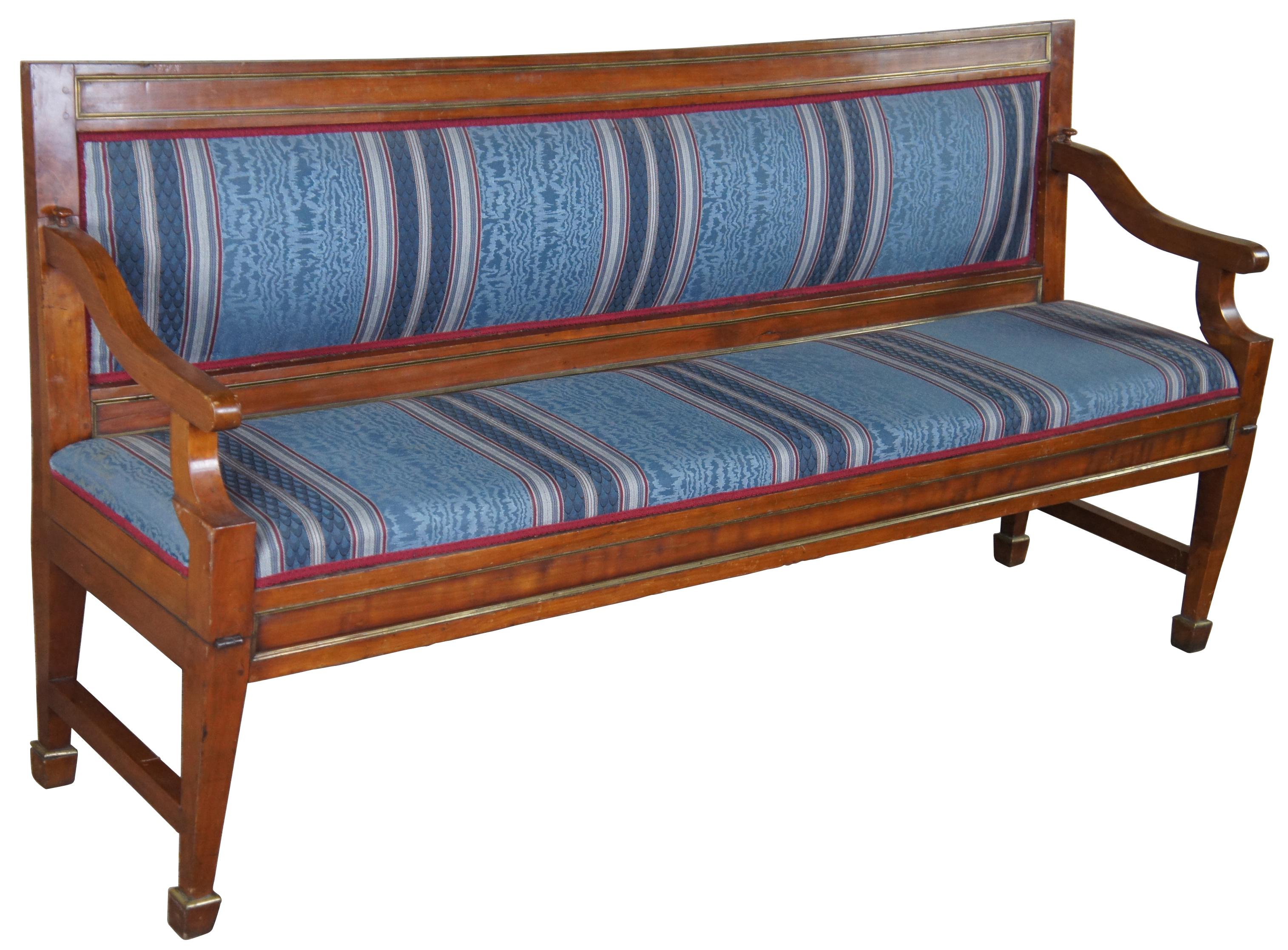 Early 19th century museum quality English Regency convertible hall bench or bed. A rectangular form made from walnut with with brass trim. Upholstered in a striped blue and red fabric with red cording. The bench is supported by square tapered legs