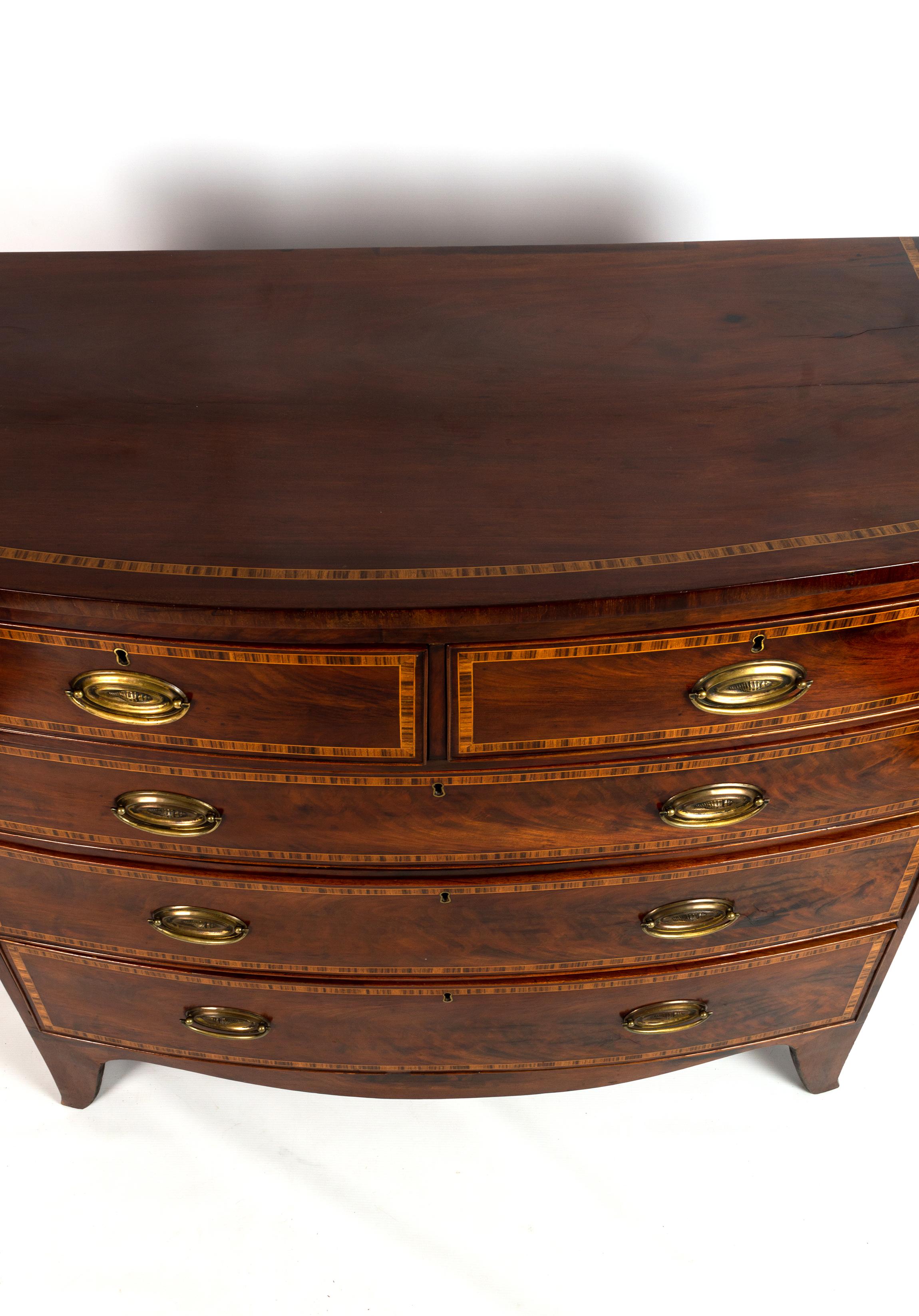 A regency mahogany and line inlaid bow front chest of drawers, early 19th century (c.1815)

A regency mahogany and line inlaid bow front chest of drawers, early 19th century, with two short over three long graduated drawers, inlaid with rosewood,