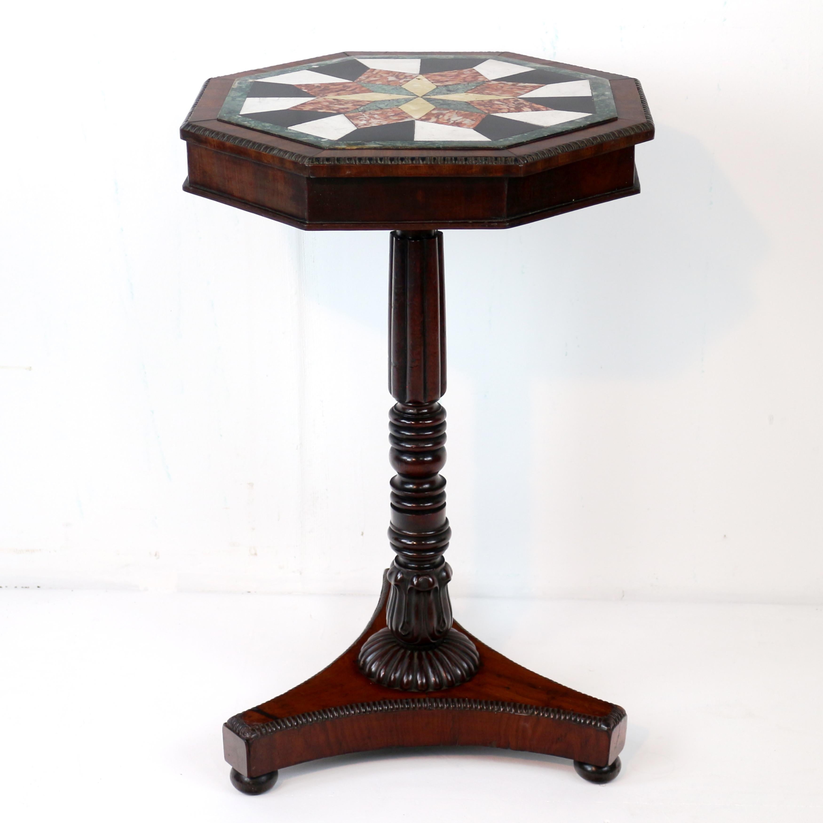 An antique Regency mahogany and specimen marble occasional table, attributable to Gillows of Lancaster and dating to c.1830.  The mahogany crossbanded octagonal top with a beaded  edge and inset with a star design using specimen marbles, raised on a