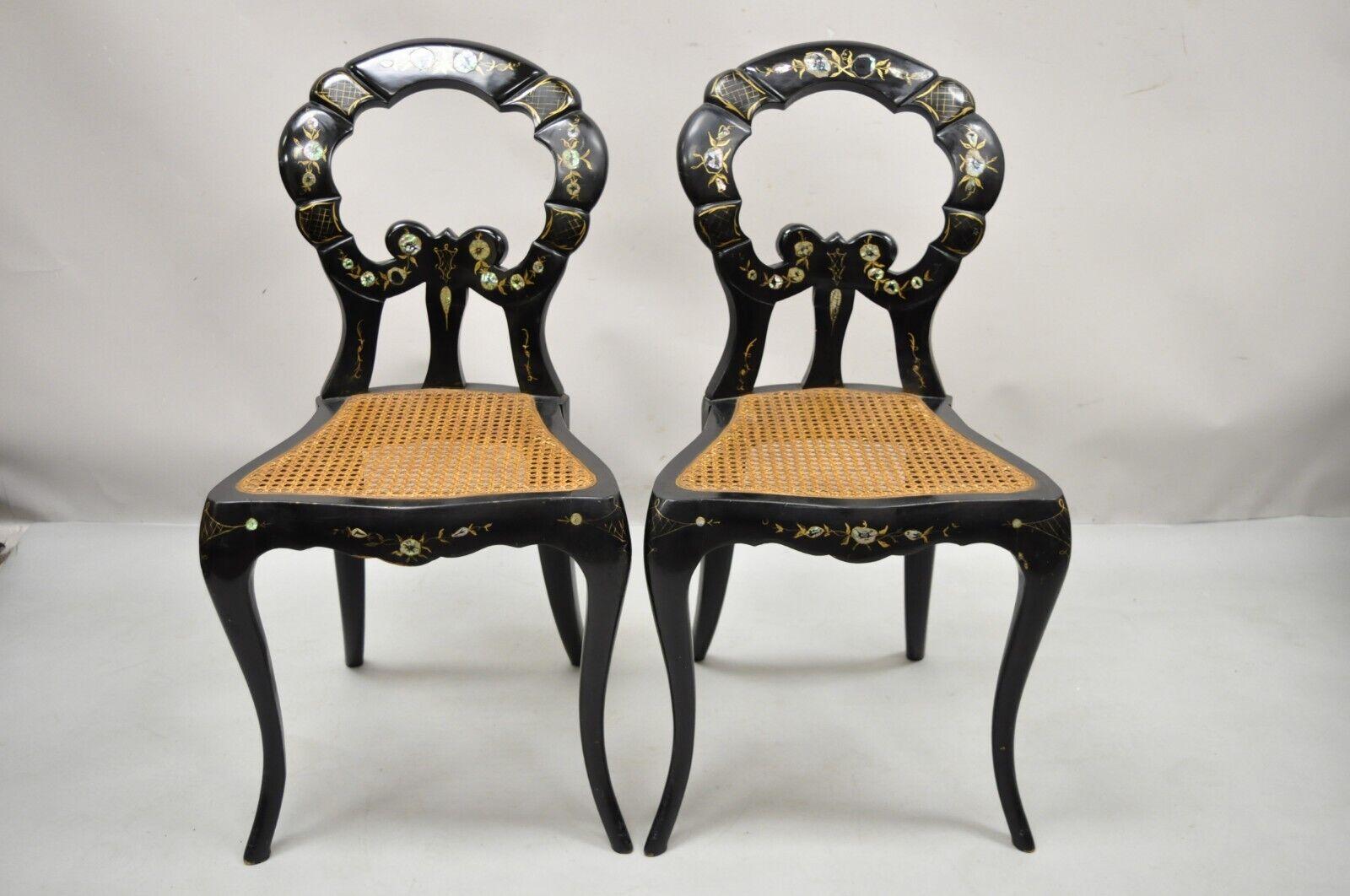 Antique English Regency Mother of Pearl Inlay Black Ebonized Side Chair - a Pair. Item features black lacquer finish, mother of pearl inlay, saber legs, cane seats, solid wood frame, very nice antique pair. Circa 19th Century. Measurements: 33