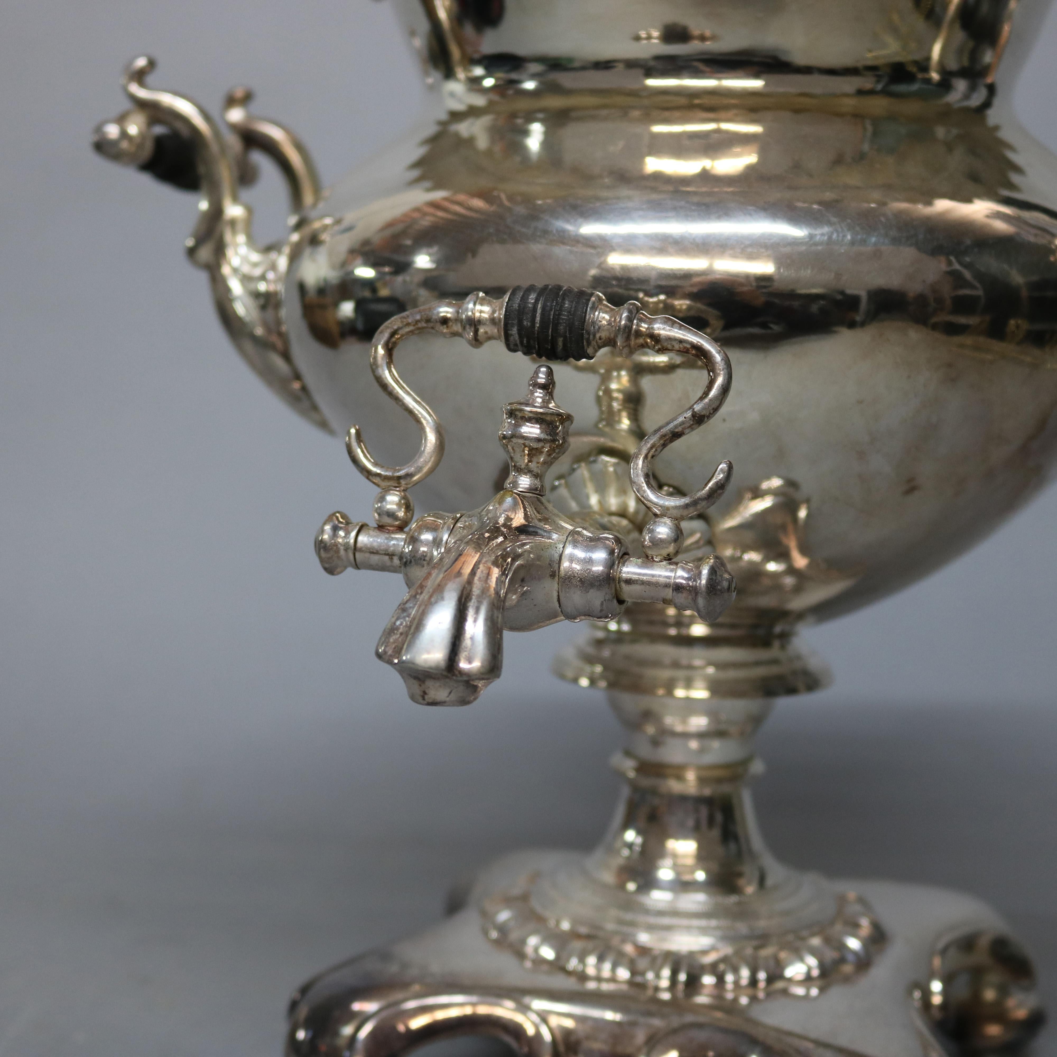 An antique English Regency silver plated samovar tea urn offers bulbous form with molded domed top, gadrooned foyer and scrollwork handles, raised on pedestal having quadruped base, circa 1890

Measures - 19.75
