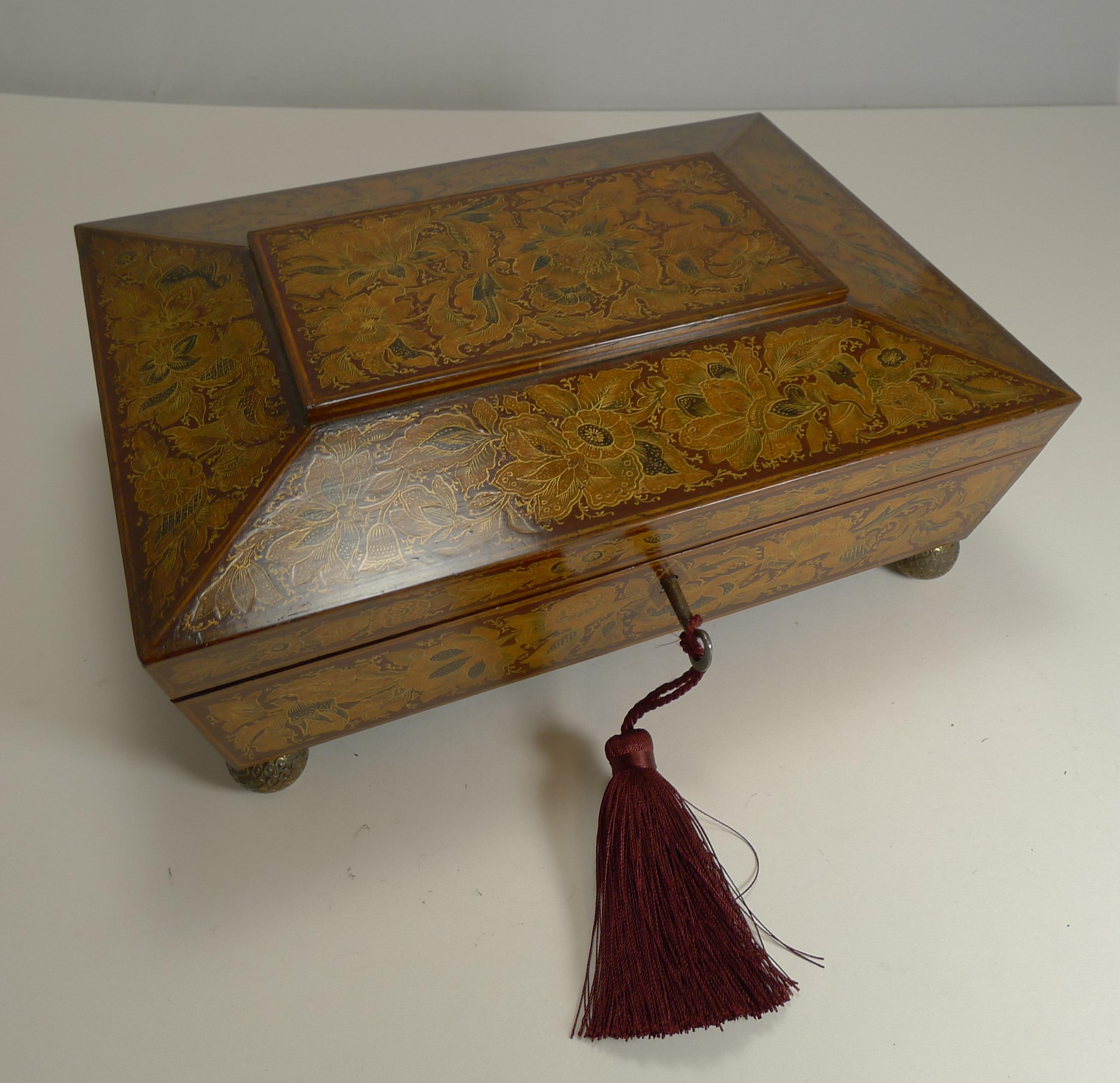 About as exotic and decorative as they get, this magnificent playing card or games box has a deep red or burgundy background which is smothered in the most exquisite fine penwork with plenty of gold creating an outstanding look. The box has been