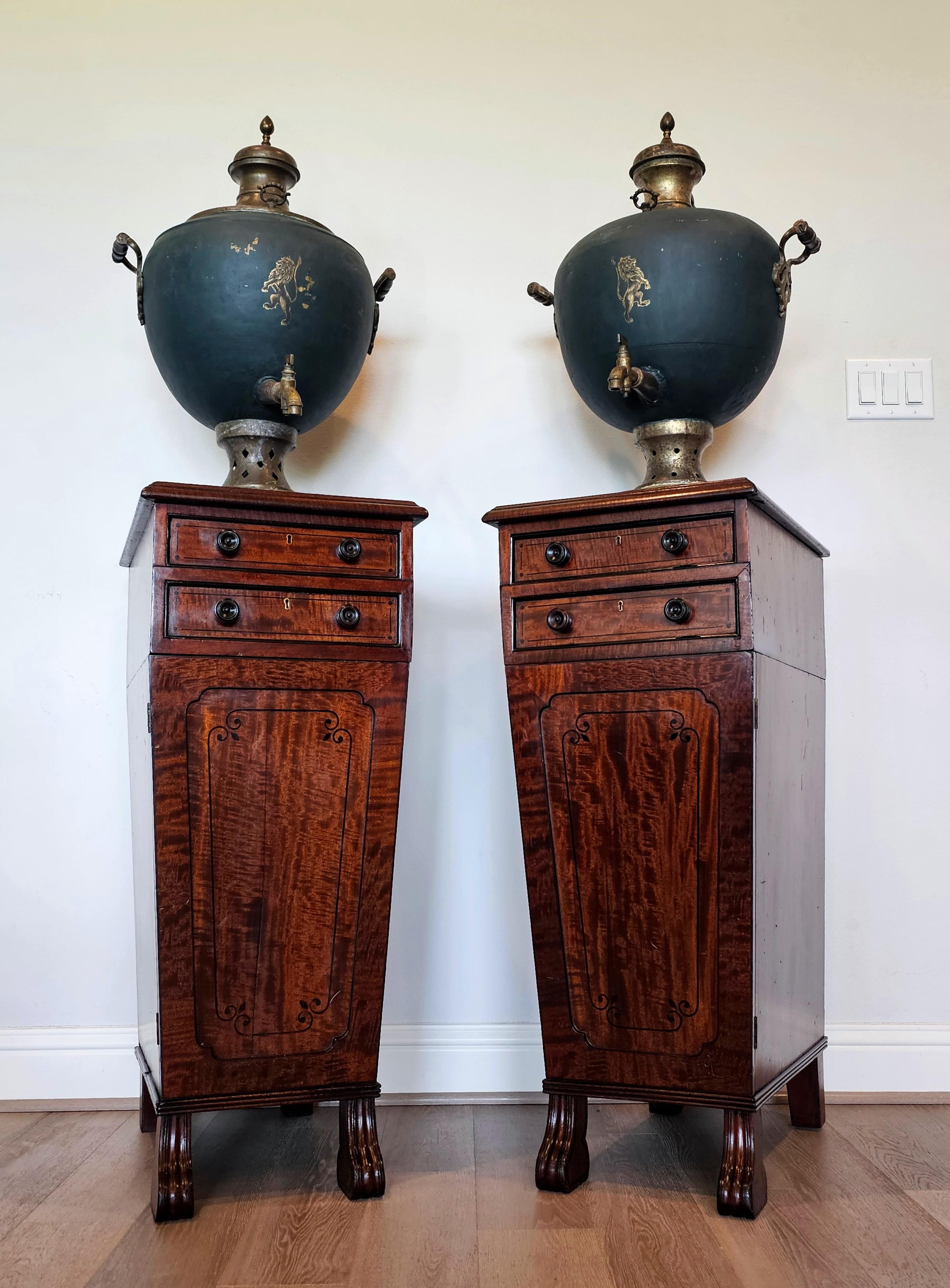 A magnificent pair of monumental antique English samovars on Regency period (1800-1830) mahogany cellarettes or liquor / wine side cabinets.

Originating in England, cellarettes were generally fine quality custom made wooden chests intended to