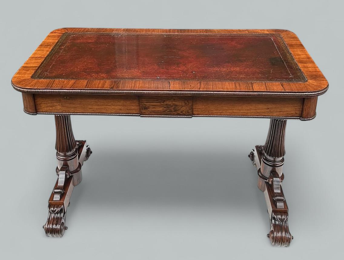 A Very Imposing example of an English well figured Rosewood Library or Writing Table firmly attributed to renowned Cabinet Makers Gillows of rectangular outline with rounded corners. Lare Regency period. 
The leather tooled writing surface with twin