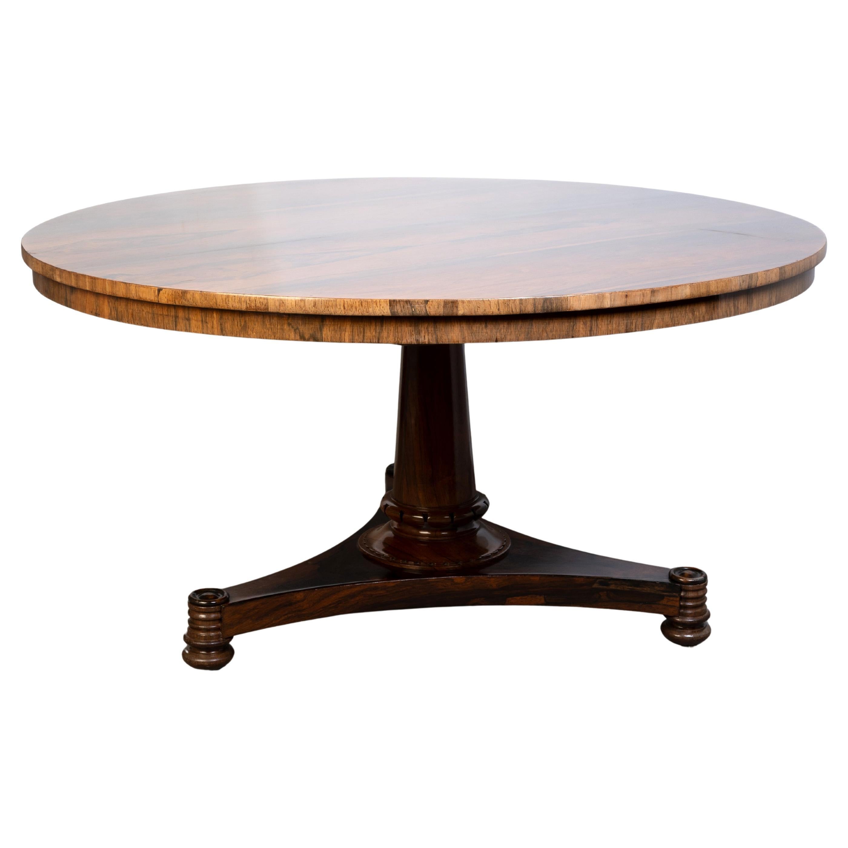 Antique English Regency Rosewood Tilt Top Centre Table C.1820, with a tapering central column with lapet carving at the base, over a tripartite base on turned feet.
Stamped 'P Campbell'

In excellent condition commensurate of age. A superficial