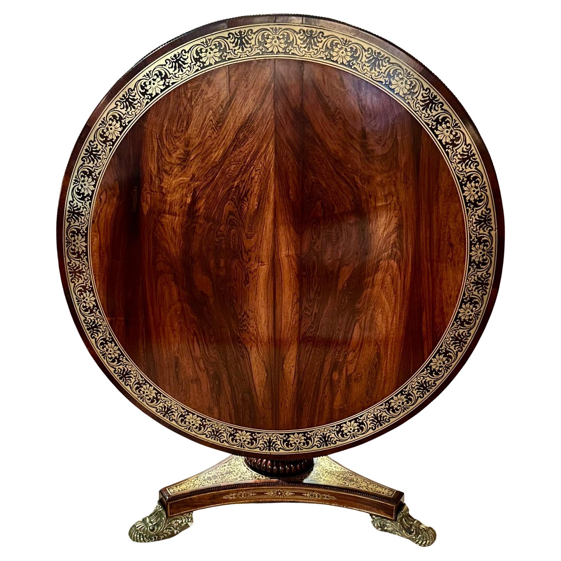 Antique English Regency Rosewood with Brass Inlay Tilt Top Center Table, Circa 1830.
Exquisite rosewood with intricate brass detailing throughout.