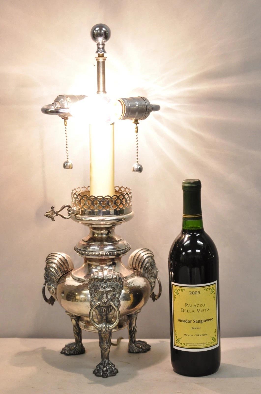 Antique English Regency Silver Plated Converted Oil Lamp Electrified Table Lamp with Lion Head Drop Ring Mounts and Ornate Paw Foot Tripod Base. Circa Early 20th Century. Measurements: 21